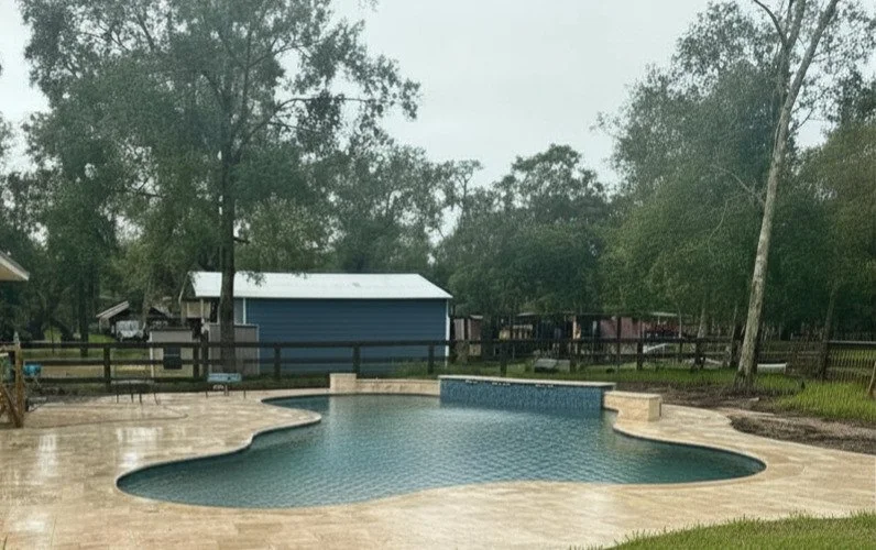 Kidney-shaped freeform gunite pool on a 2.5-acre country lot in Needville, TX