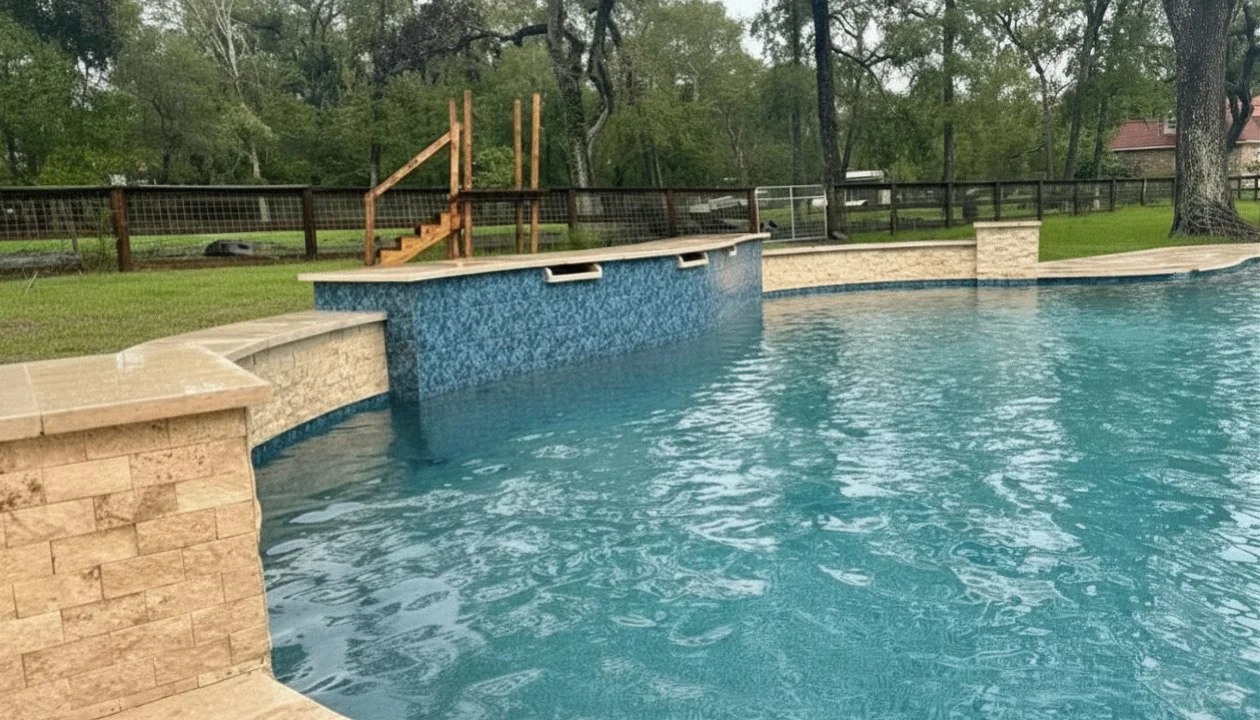 Water features spilling into the deep end of a Cadet Blue freeform pool