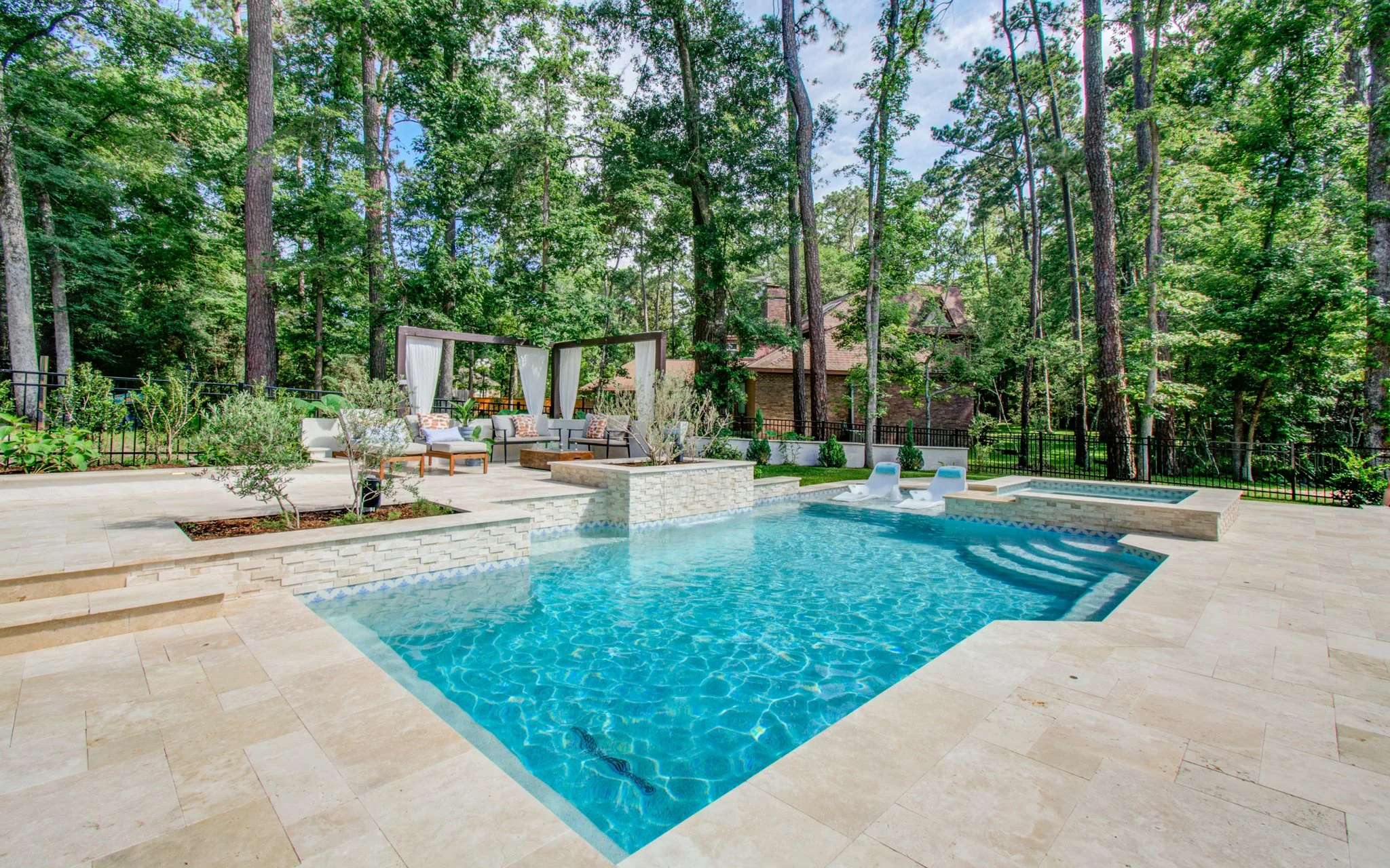 Wet Edge Signature Matrix Coastal Blue plaster with ivory travertine decking
