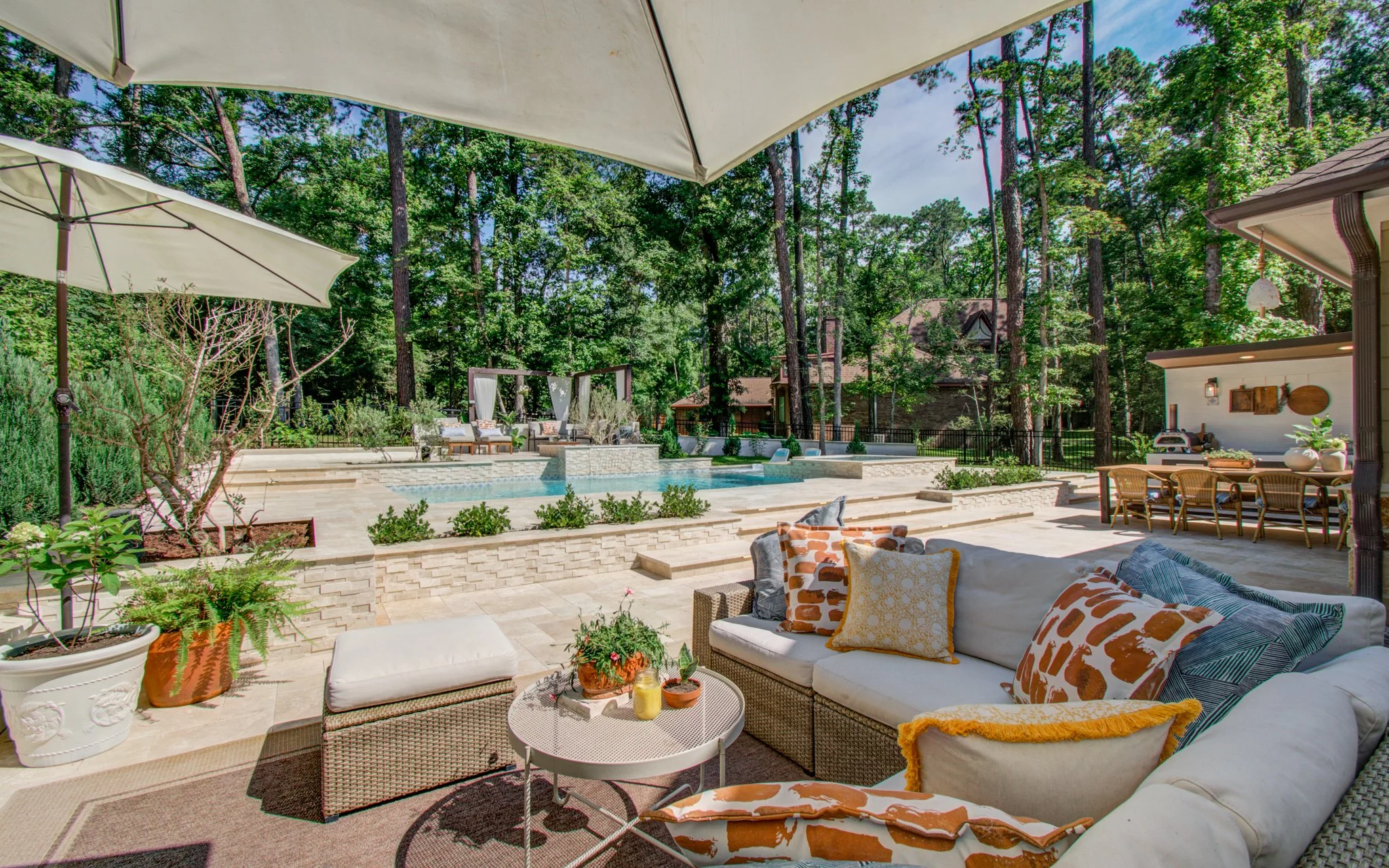 Backyard pool and spa framed by preserved pines in Willowridge Estates, Conroe