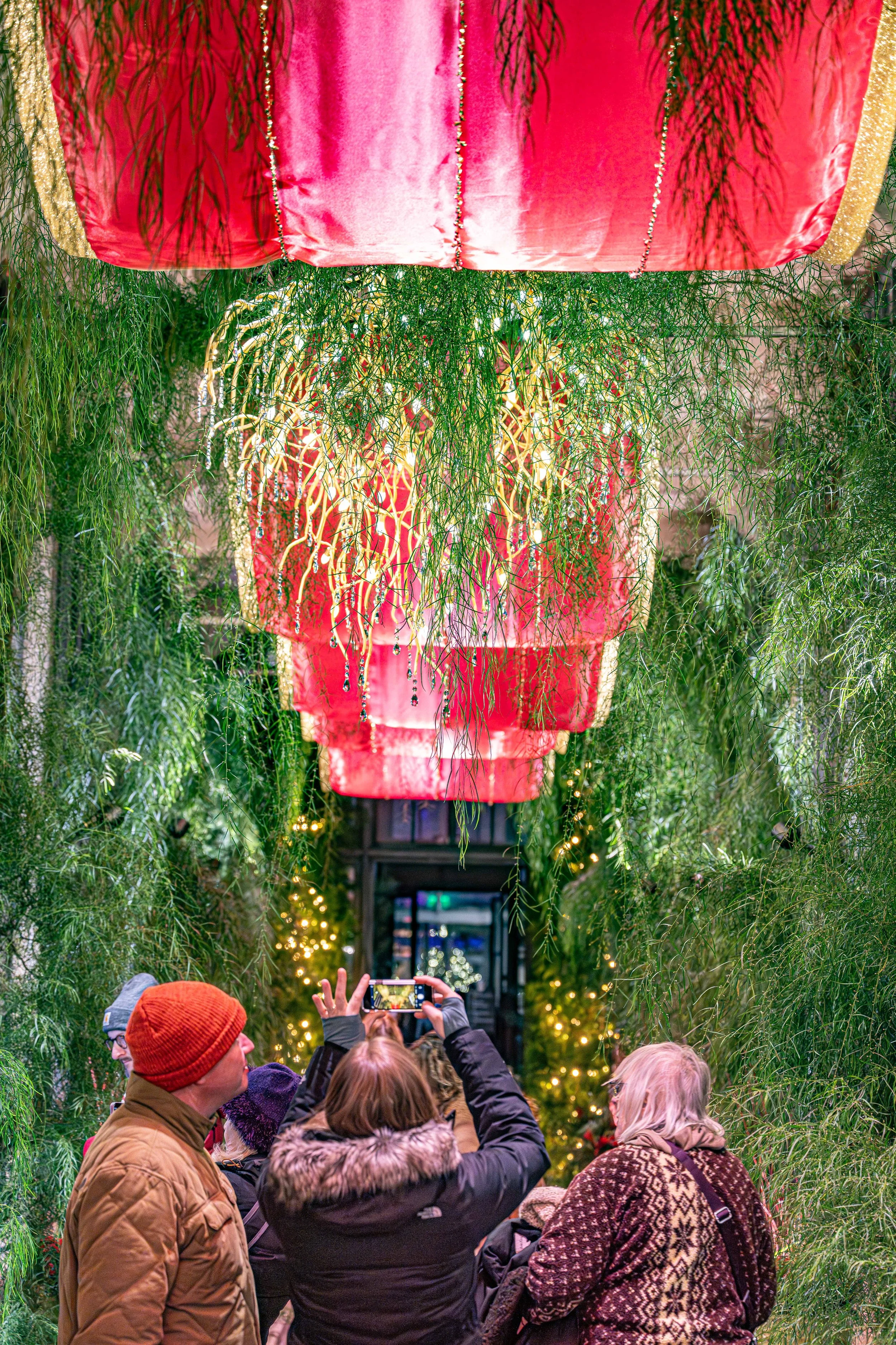 Visitors take pictures of the decorations in Longwood Gardens' Acacia Passage