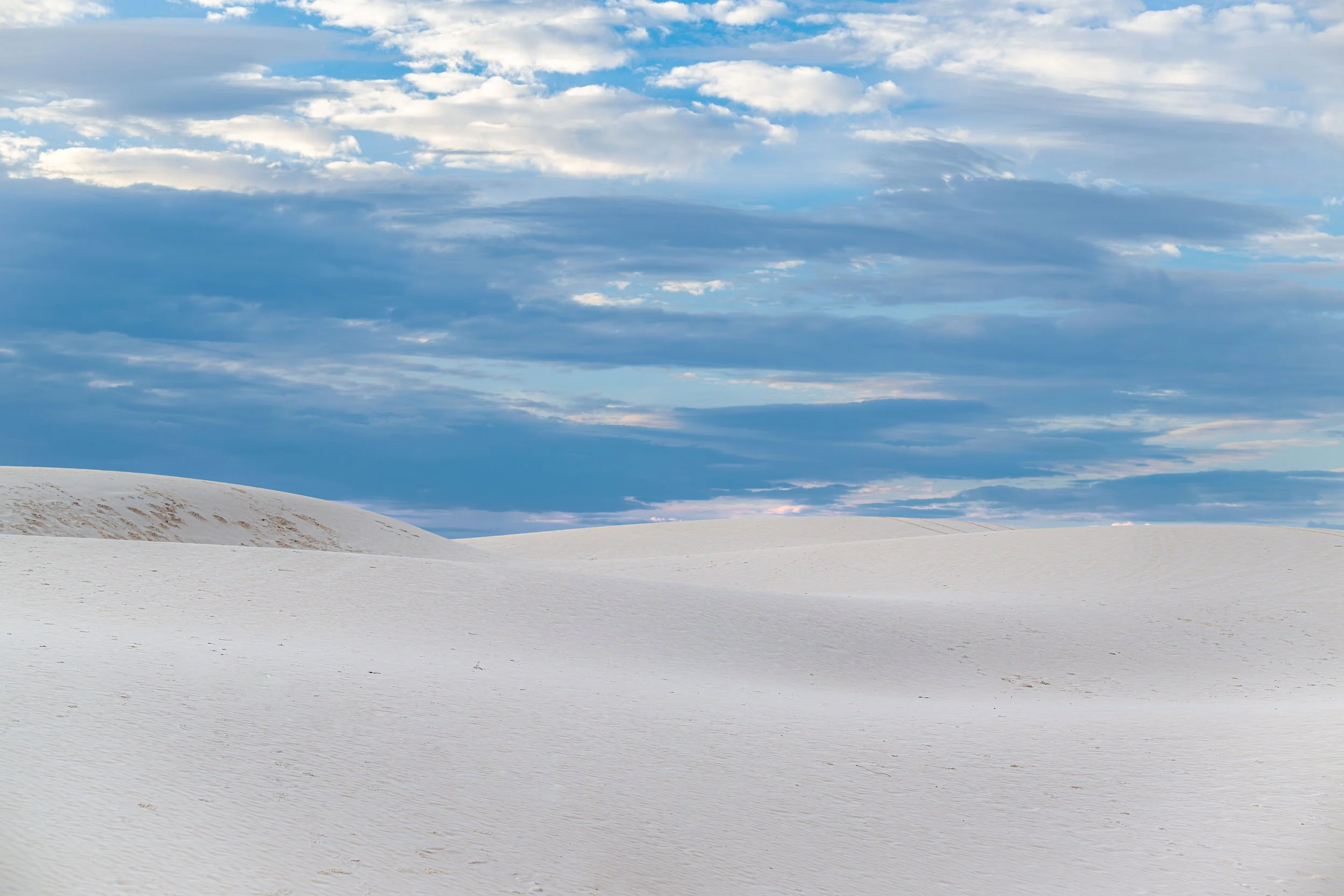 White sands gypsum dune at sunset with blue skies