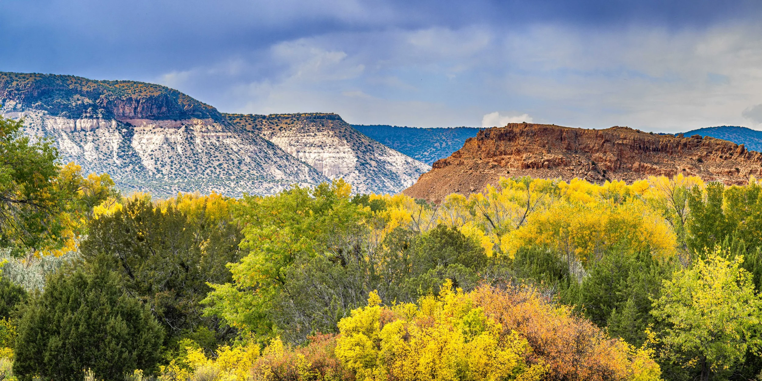 Fall colors set against colorful geological formations along Route 84 in Abiquiu