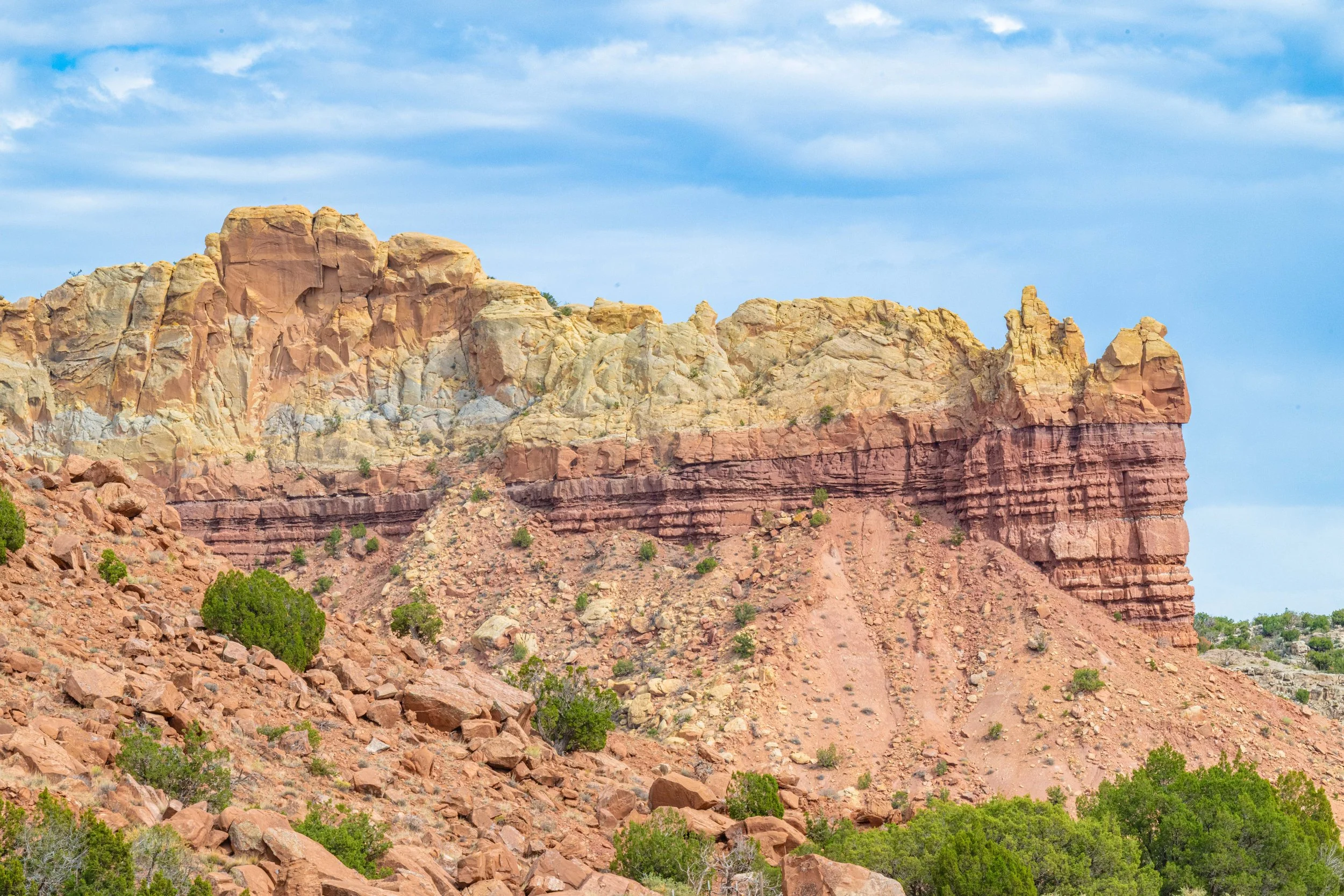 A stratified rock formations displays brilliant colors from 300 million years of history