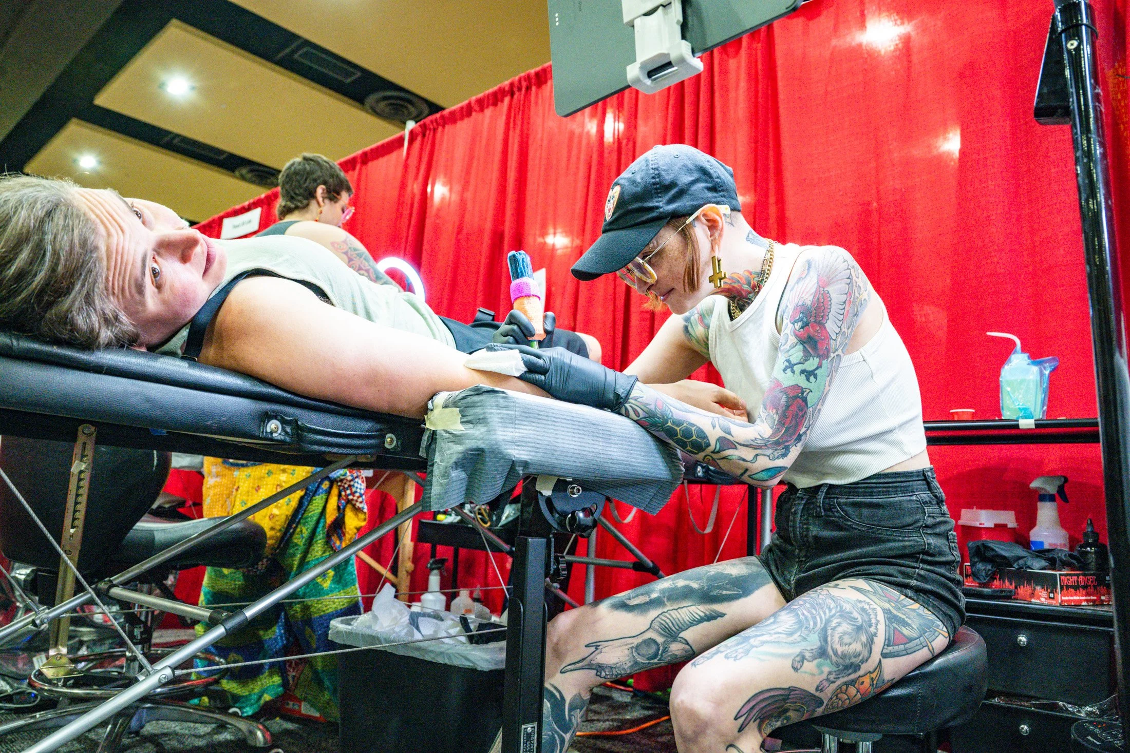 Hadassah Wilson of Lancaster gets a tattoo from Danielle Brown inside the convention center at the 17th Annual Lancaster Pride Festival.