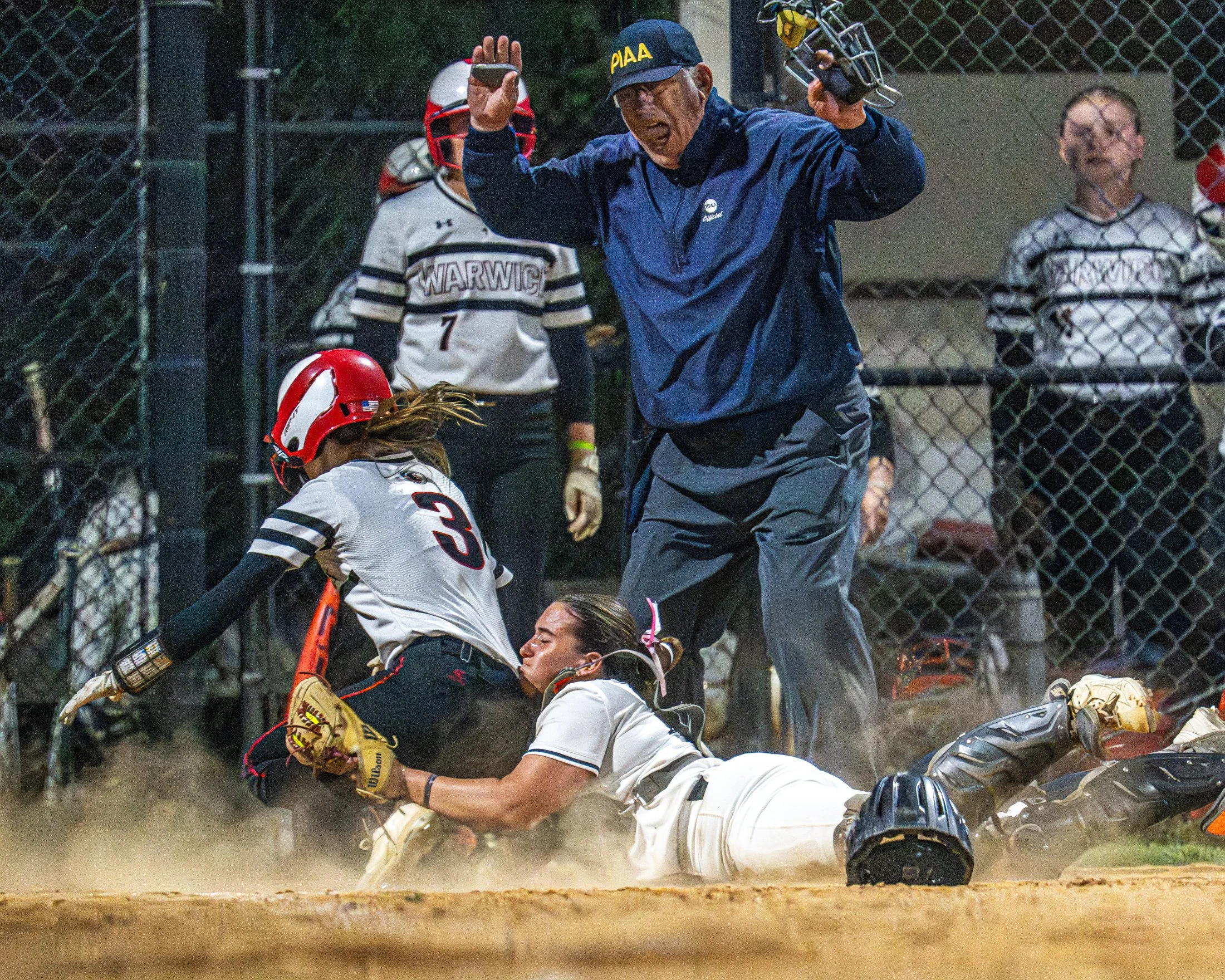 Manheim Township catcher Paige Hughes collides with Warwick's Sydney Lee at home plate during a softball game versus Warwick. Lee was called safe and Warwick later won the game 10-9 scoring four runs in the top of the 7th inning.