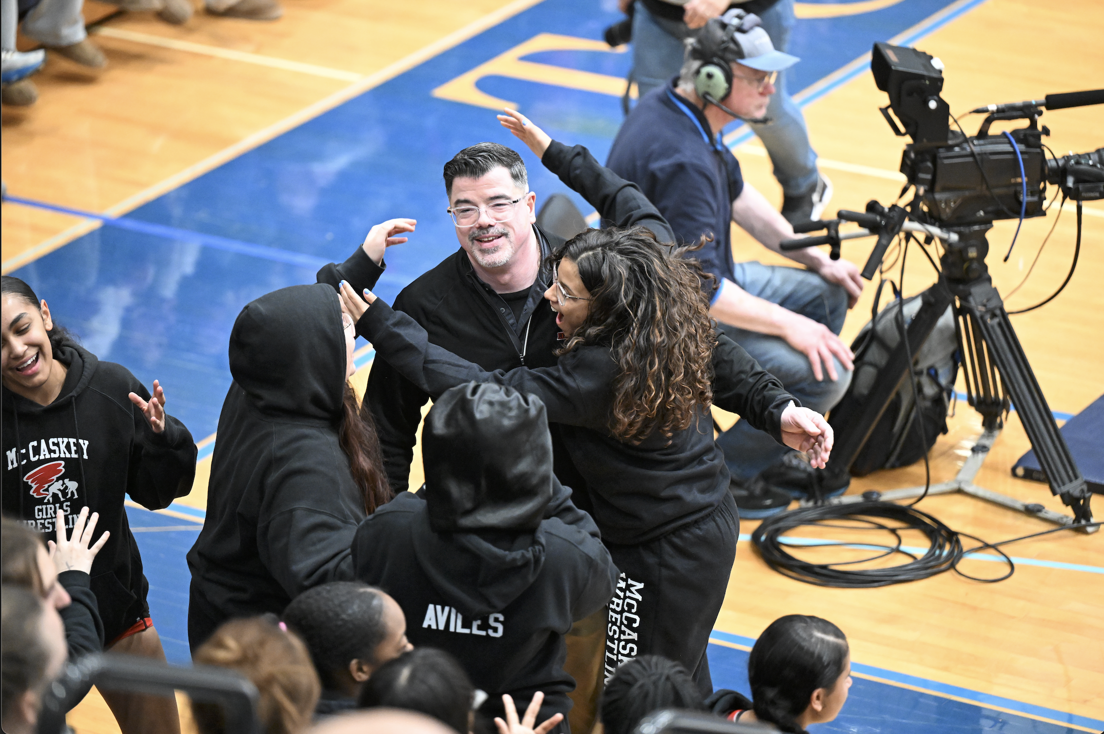 McCaskey coach Kevin Franklin is rushed by his players after being inducted into the L-L League Hall of Fame.
