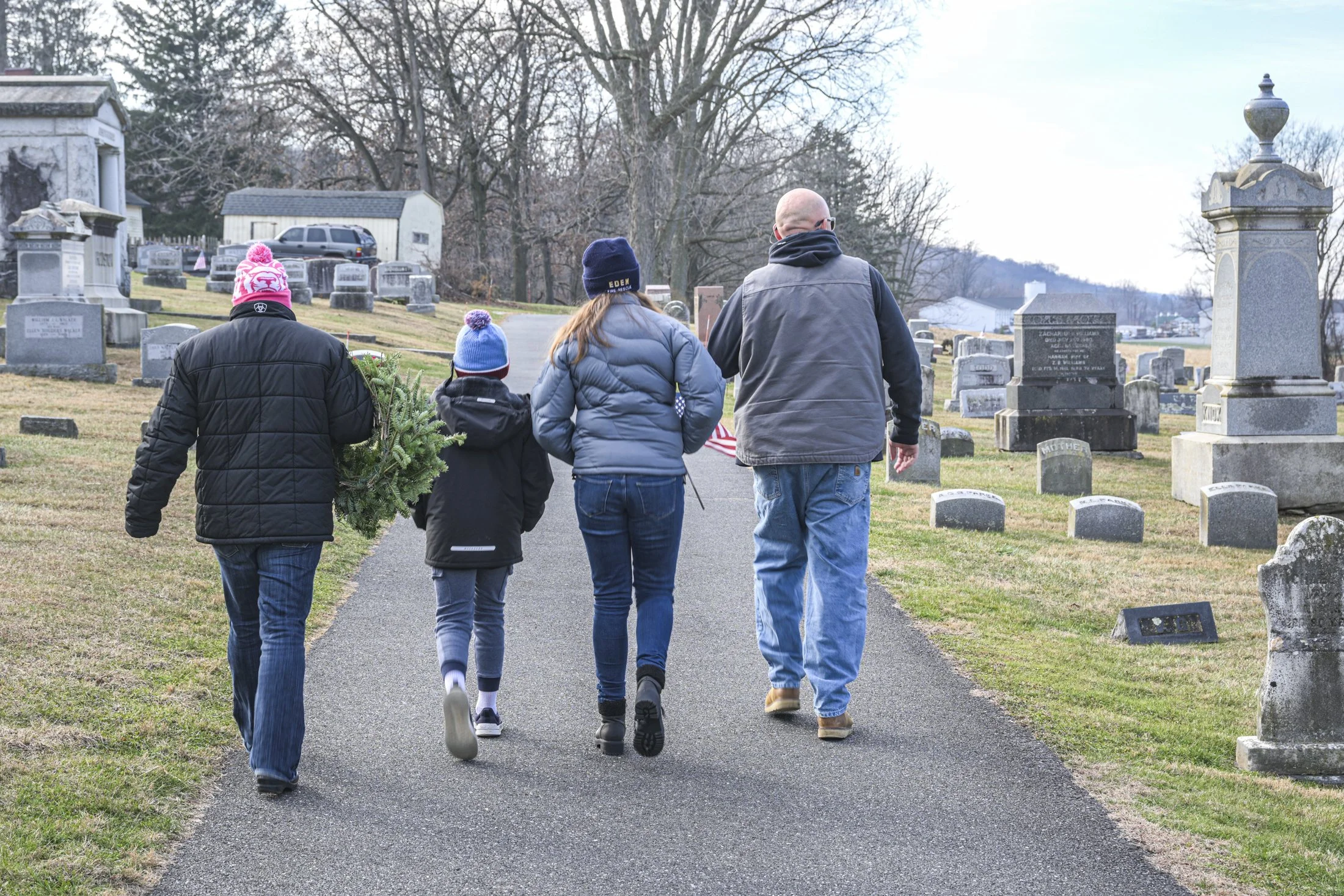 The Slaymaker family of Gap walks to a family grave. The family volunteered afterward to lay wreaths on other veteran graves as part of Wreaths Across America.