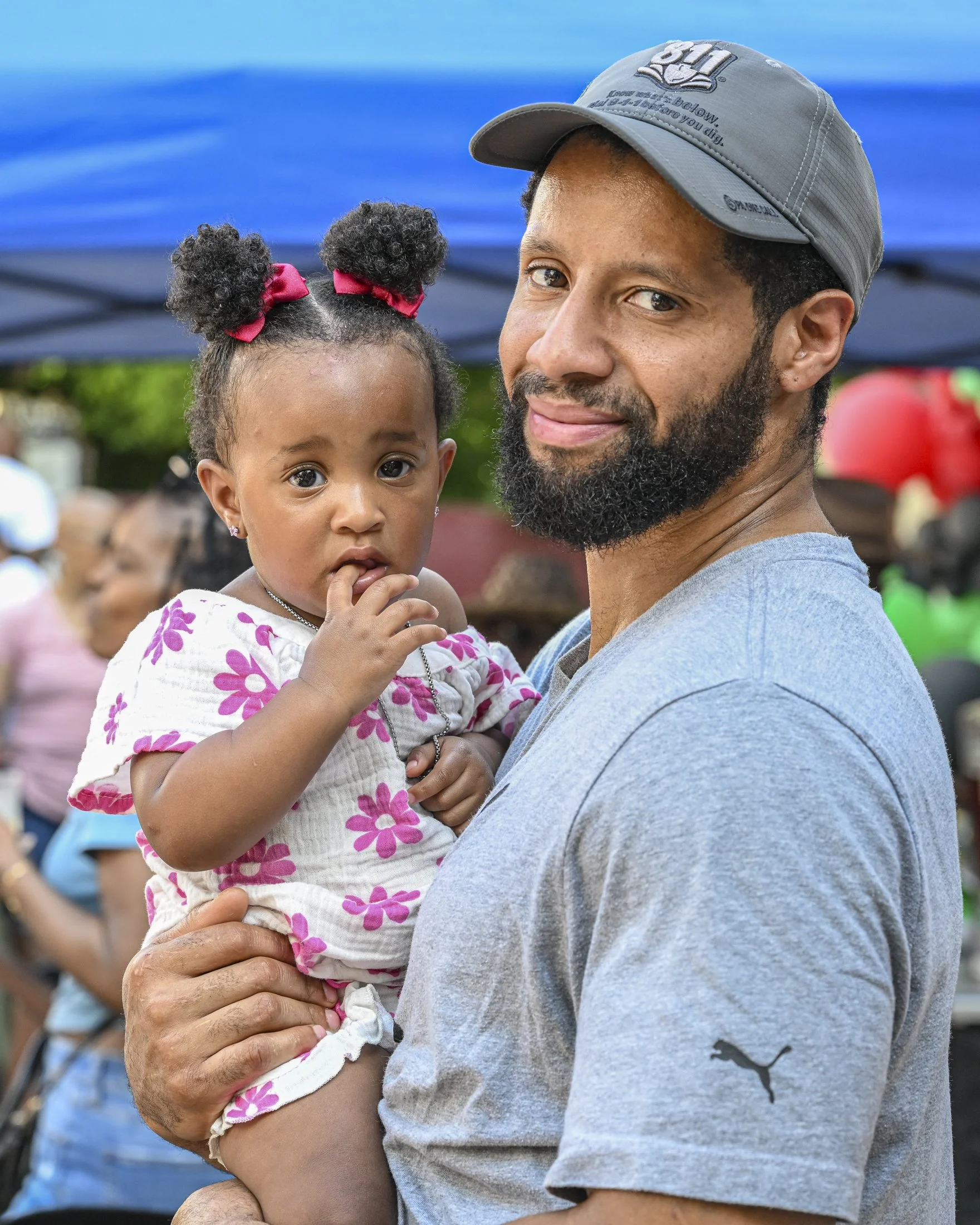 Dante Menter of Lancaster holds his daughter Ivy during the Juneteenth mixer on Sunday, Jun. 22, 2025.