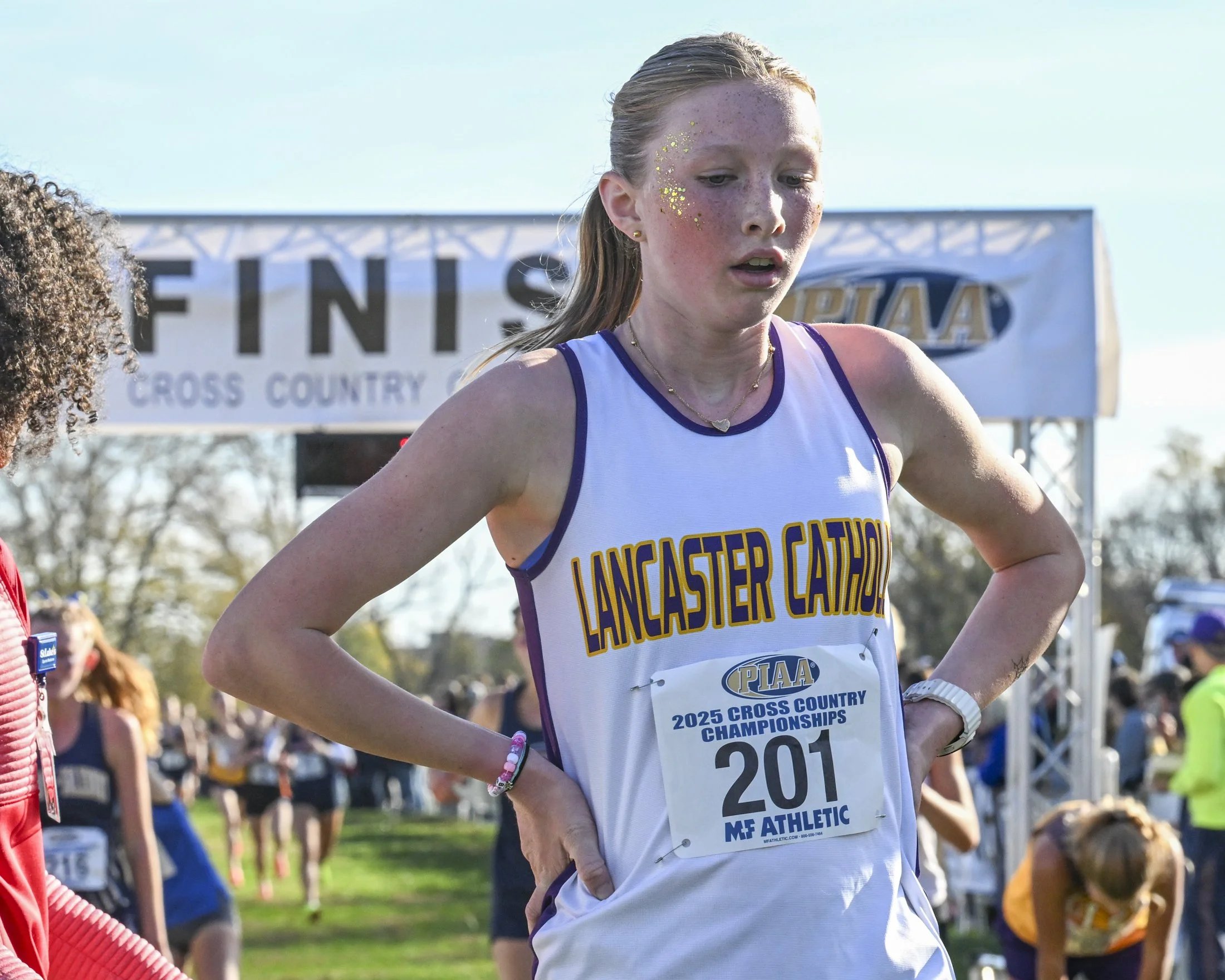 An exhausted Leah Droter of Lancaster Catholic crosses the finish line in 12th place at the 2025 PIAA Cross Country Championship held on Saturday, November 1st, 2025.