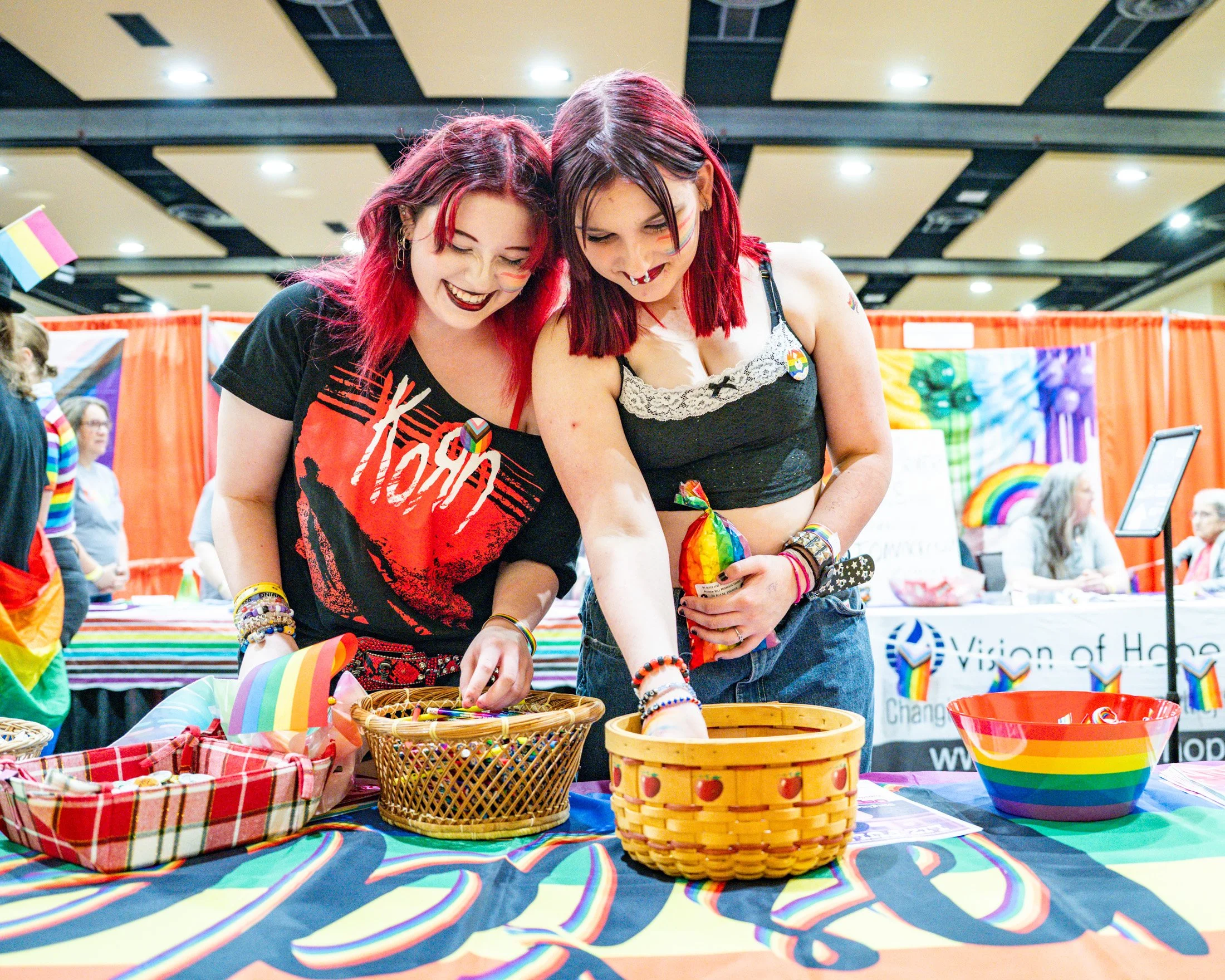 Makayla Reber and Alice Hickey of Elizabethtown, PA check out booth merchandise from St. Matthew Lutheran Church inside the convention center at the 17th Annual Lancaster Pride Festival on Saturday, Jun. 28th, 2025. Event organizers expected approxim