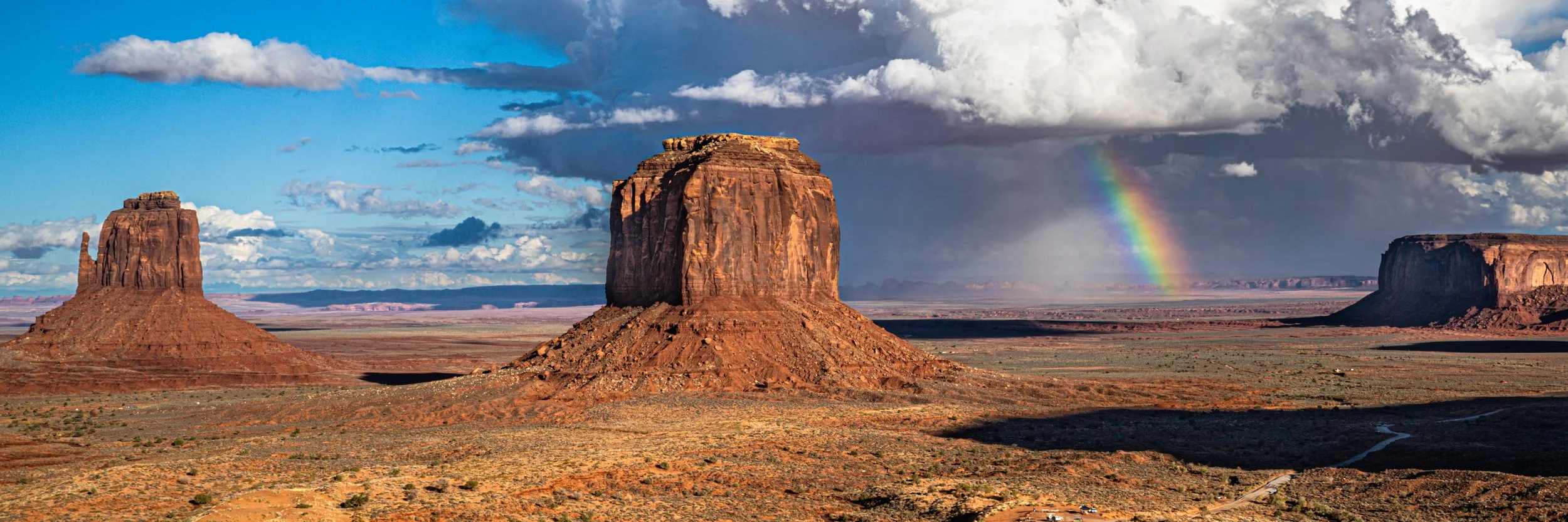 A rainbow in Monument Valley with Merrick Butte and the east Mitten Butte