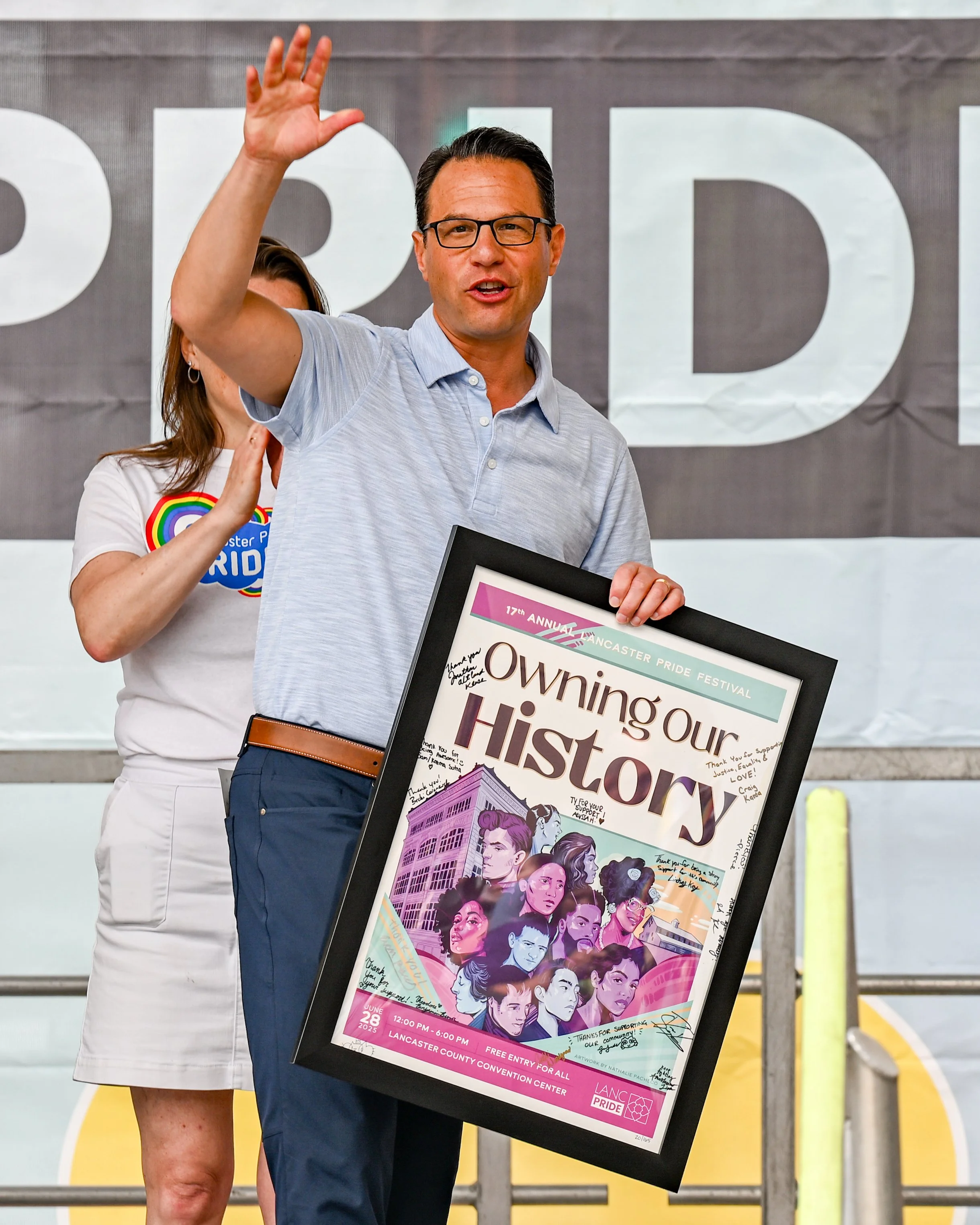 Josh Shapiro, Governor of the Commonwealth of Pennsylvania, waves to the crowd after receiving a signed poster celebrating the 17th Annual Lancaster Pride.