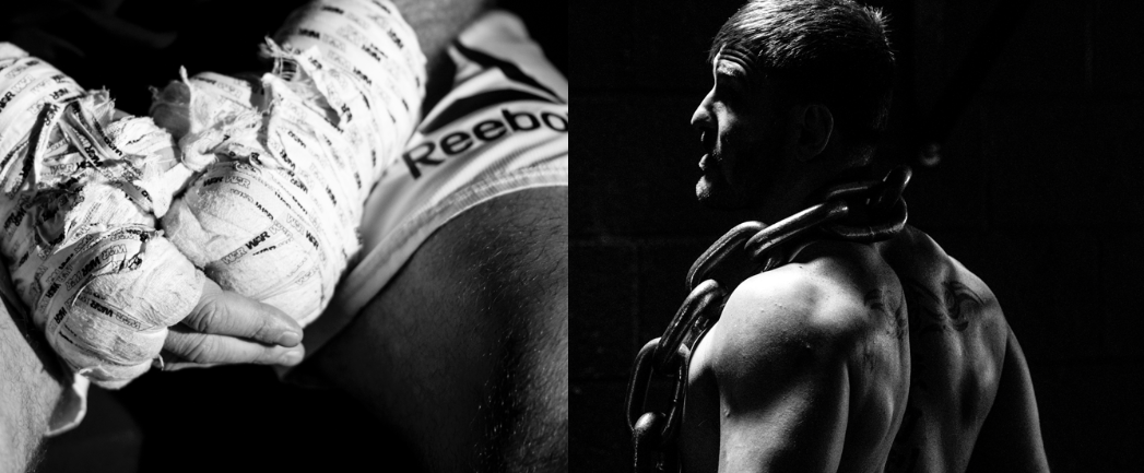 Close-up of a newborn baby wrapped in newspaper, cradled in hands on the left; muscular man with tattoos and a chain around his neck, looking to the side in a dimly lit environment on the right.