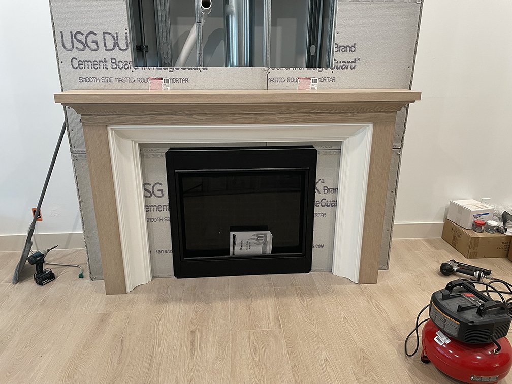 Fireplace mantle surround. White oak with white trim. Designed by Timeless Oak Designs