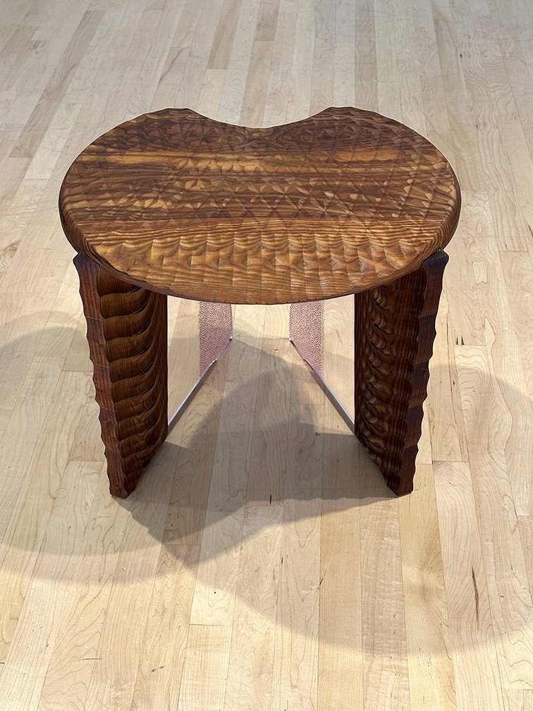 Shimmer detail. A pair of stools designed to be activated by rain. Water is guided down the carved profiles of the seat onto the protruding legs