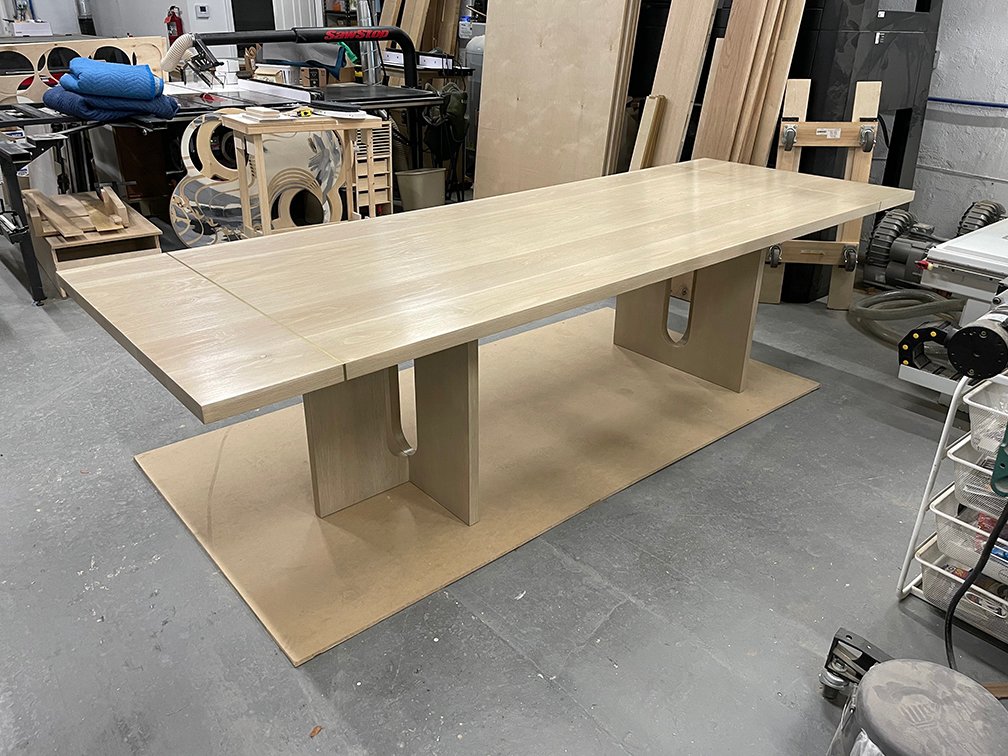 White oak table with brass inlay and multi-plane bases, design by Timeless Oak Designs