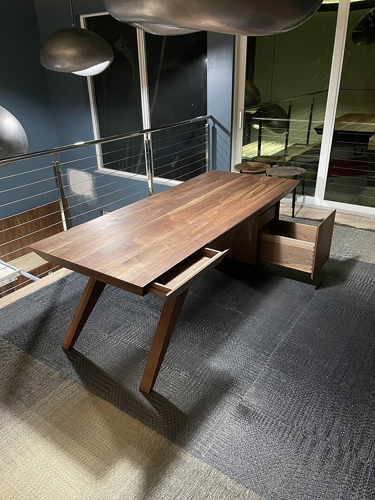 A pair of solid black walnut desks. Other than cabinet drawer glides, and some brass/stainless steel custom made legs, there is no hardware in this piece. Designed by G+U Architects