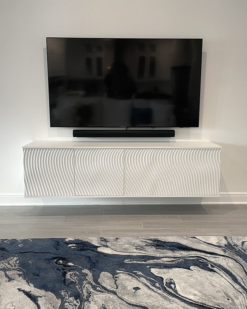 Floating console. Cnc routed undulating pattern on front