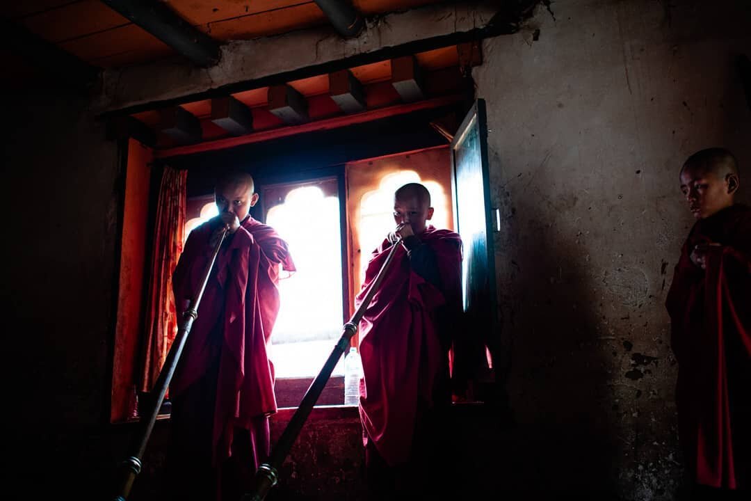 Buddhist monks-in-training practicing the longhorn (Dungchen) at a monastery in Bhutan. Besides Buddhist teachings, the children here have a curriculum of learning English, Mandarin, sciences, and history. I was extremely privileged to visit this pla