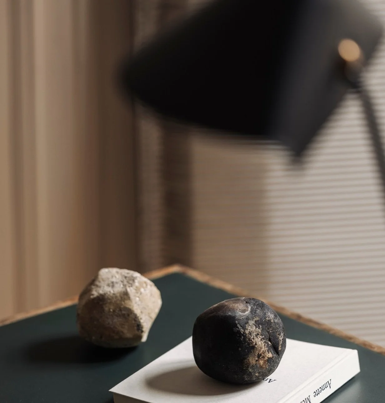 Unaltered and unassuming &mdash; these hand-shaped stones by @marlieshuybs.be carry a quiet force. Displayed as sculptural objects, they invite pause, grounding the modern interior with their silent weight and primal texture. A meditation on form, co