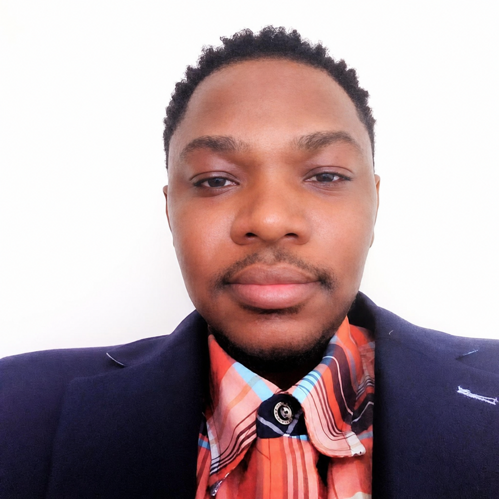 A young guy wearing black in an office background. 
