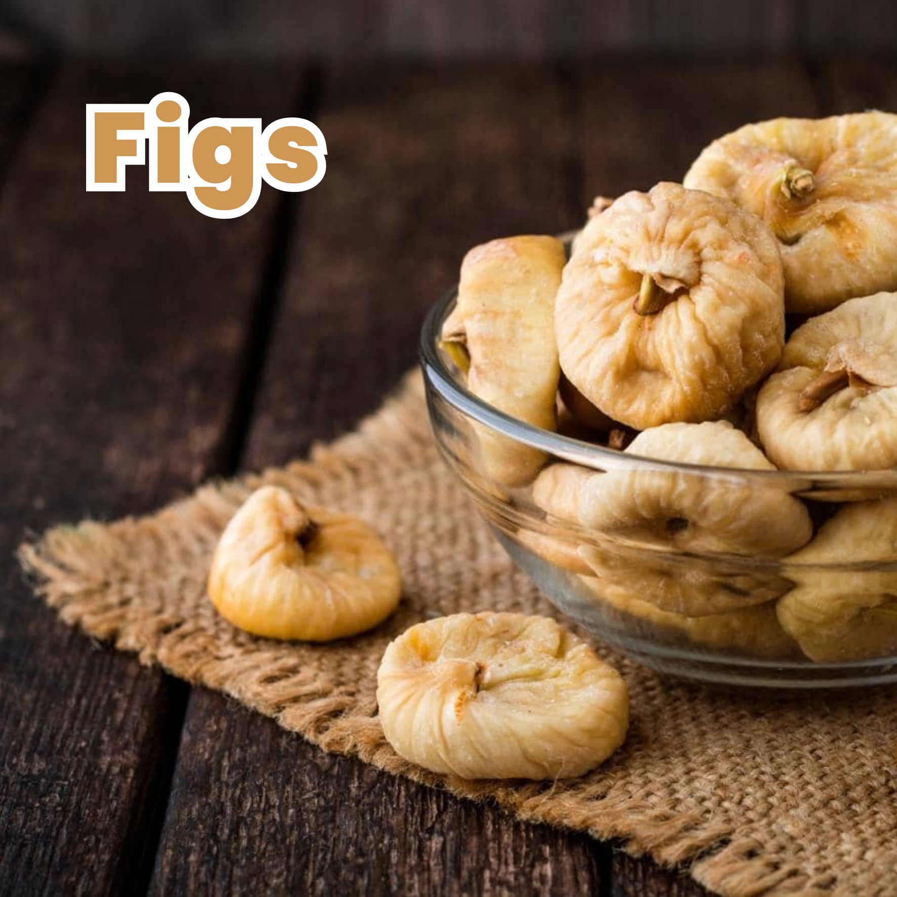A glass bowl filled with dried figs on a wooden surface with a textured cloth, with some figs outside the bowl.