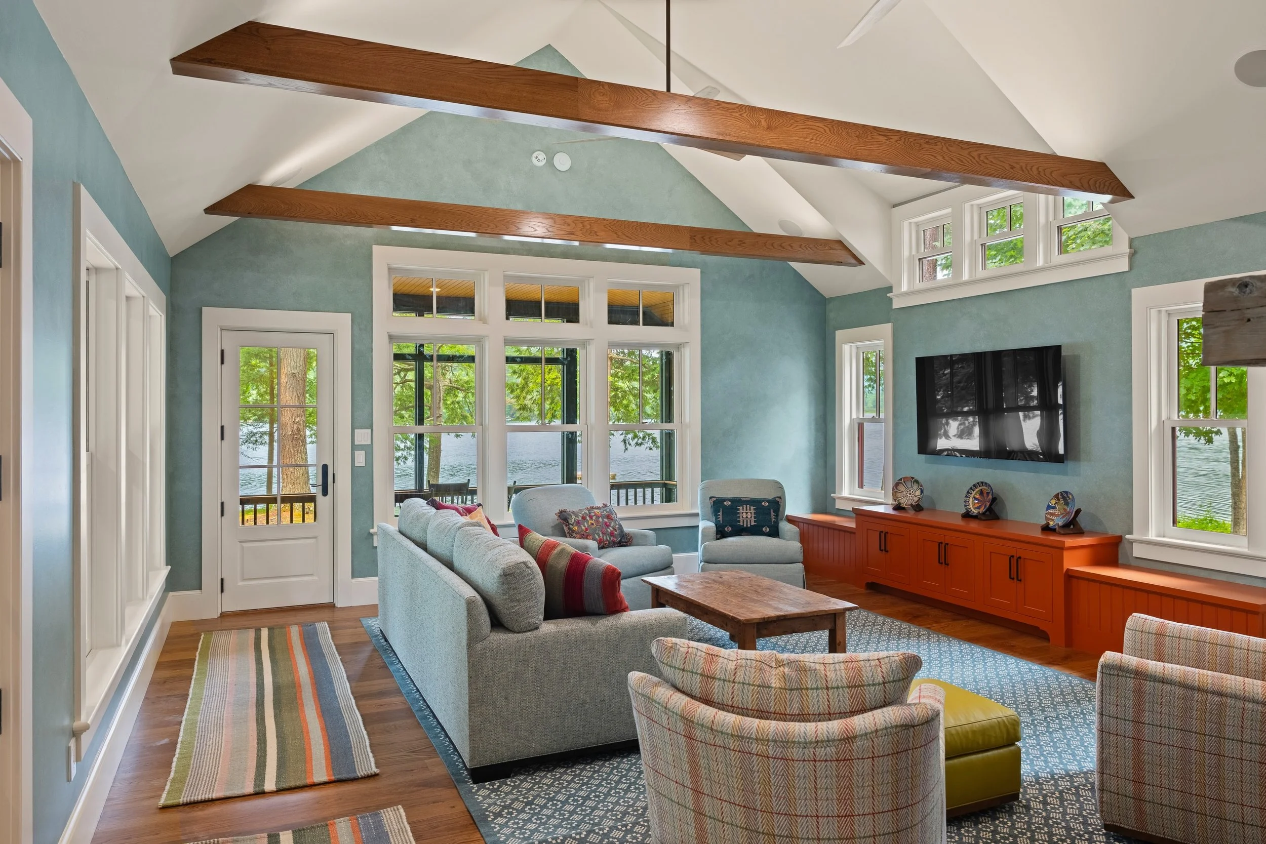 A little overwhelmed by how many cool features in this living room.

- custom built-in console 
- decorative painting on the walls
- stone and tile on the fireplace
- beam work 
- THE VIEW!

So many talented crafts men and women chipped in here. Stun