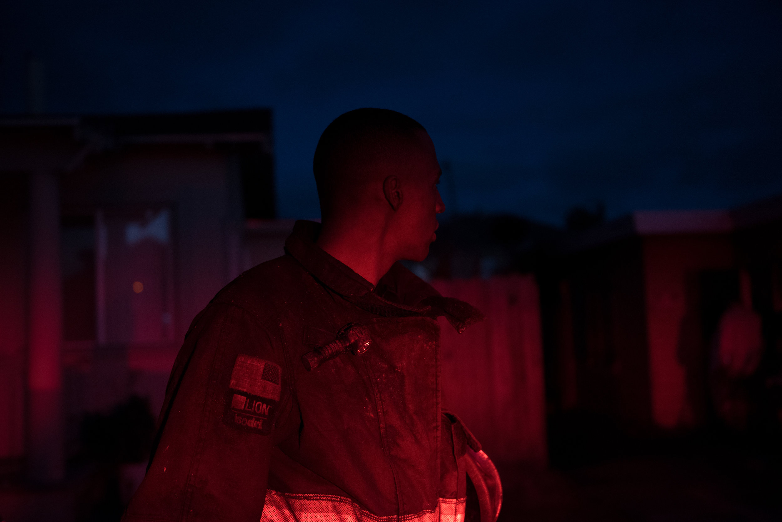  Firefighter Paul Mason Jr looks back at a burned house after fighting his first fire on Monday, June 26, 2017. | Rosa Furneaux for the East Bay Express 