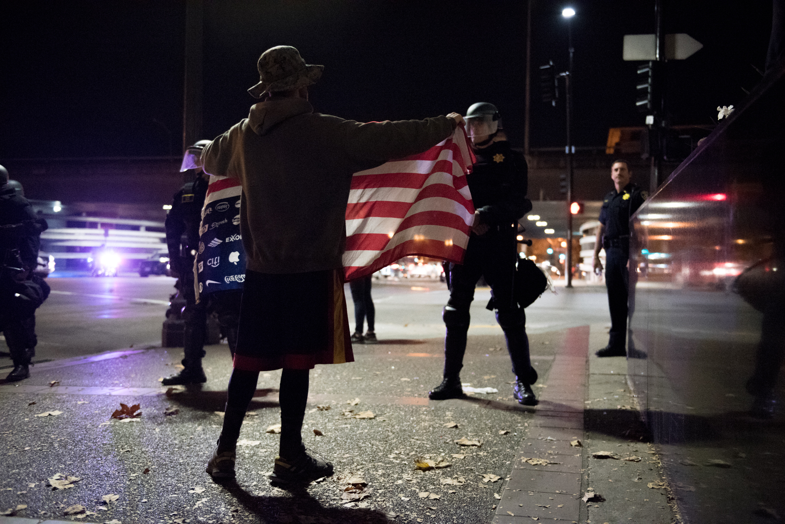  A protester stands in front of a police line on Broadway, near Interstate 880, in Oakland on Friday, October 11, 2016. | Rosa Furneaux/Oakland North 
