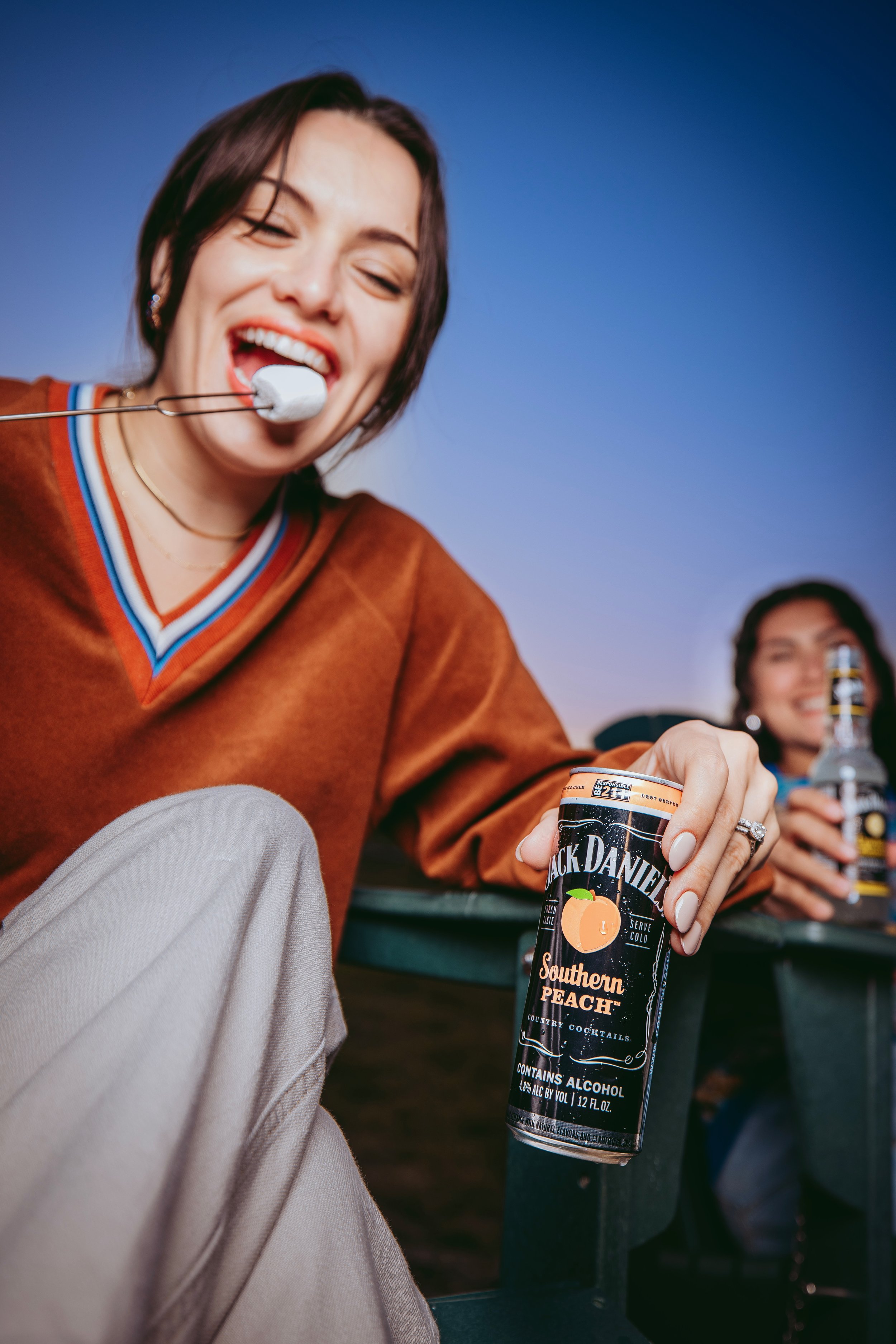 Commercial lifestyle beverage and food product photography featuring Gen Z and millennial talent in an outdoor sunset setting, using warm natural light and vibrant styling to create an eye-catching, high-impact image for alcohol brands, social media.