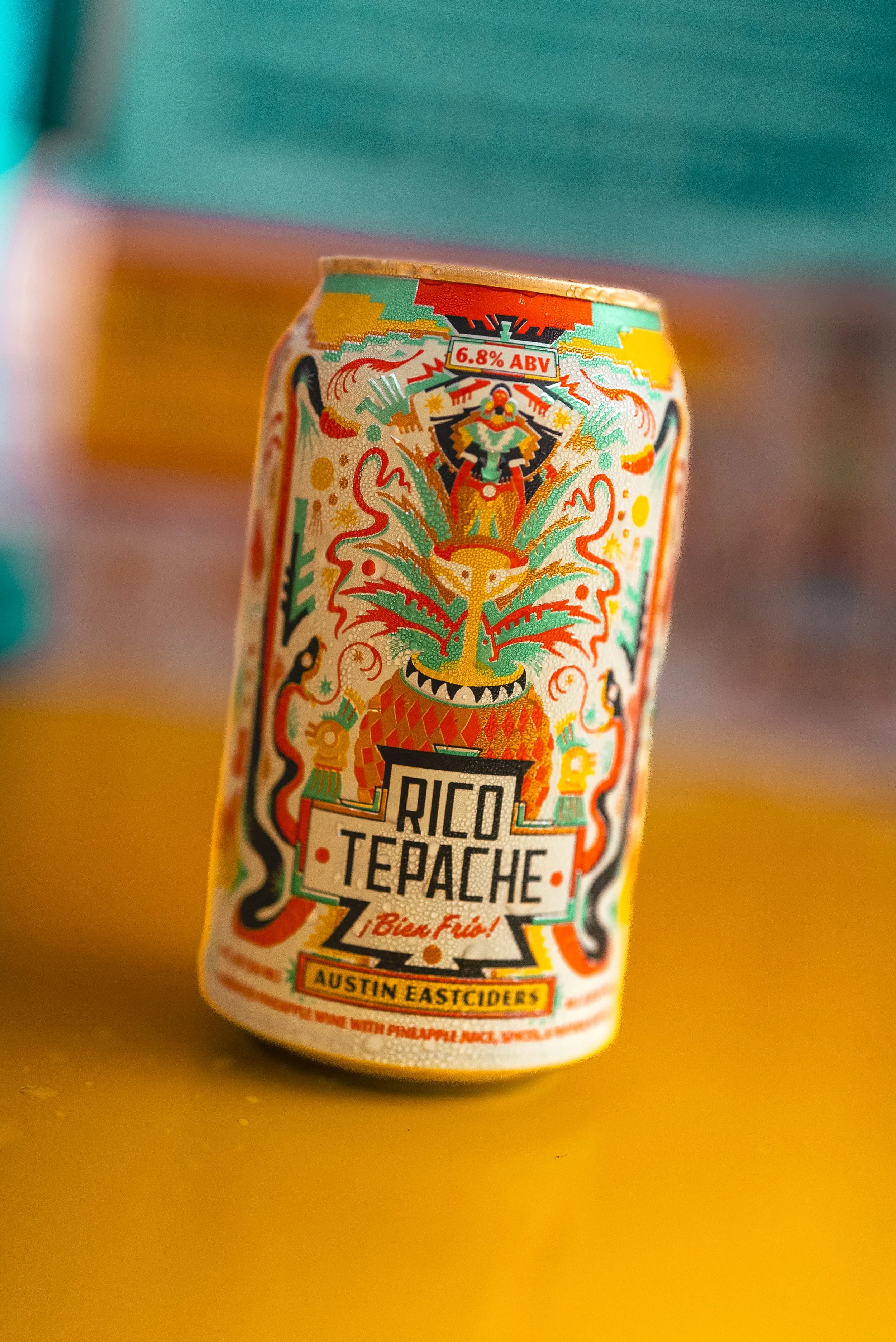 Commercial beverage and food product photography of Rico Tepache by Austin Eastciders, featuring vibrant color, bold styling, and artistic composition with tropical design elements, creating an eye-catching, high-impact visual for alcohol brands, soc