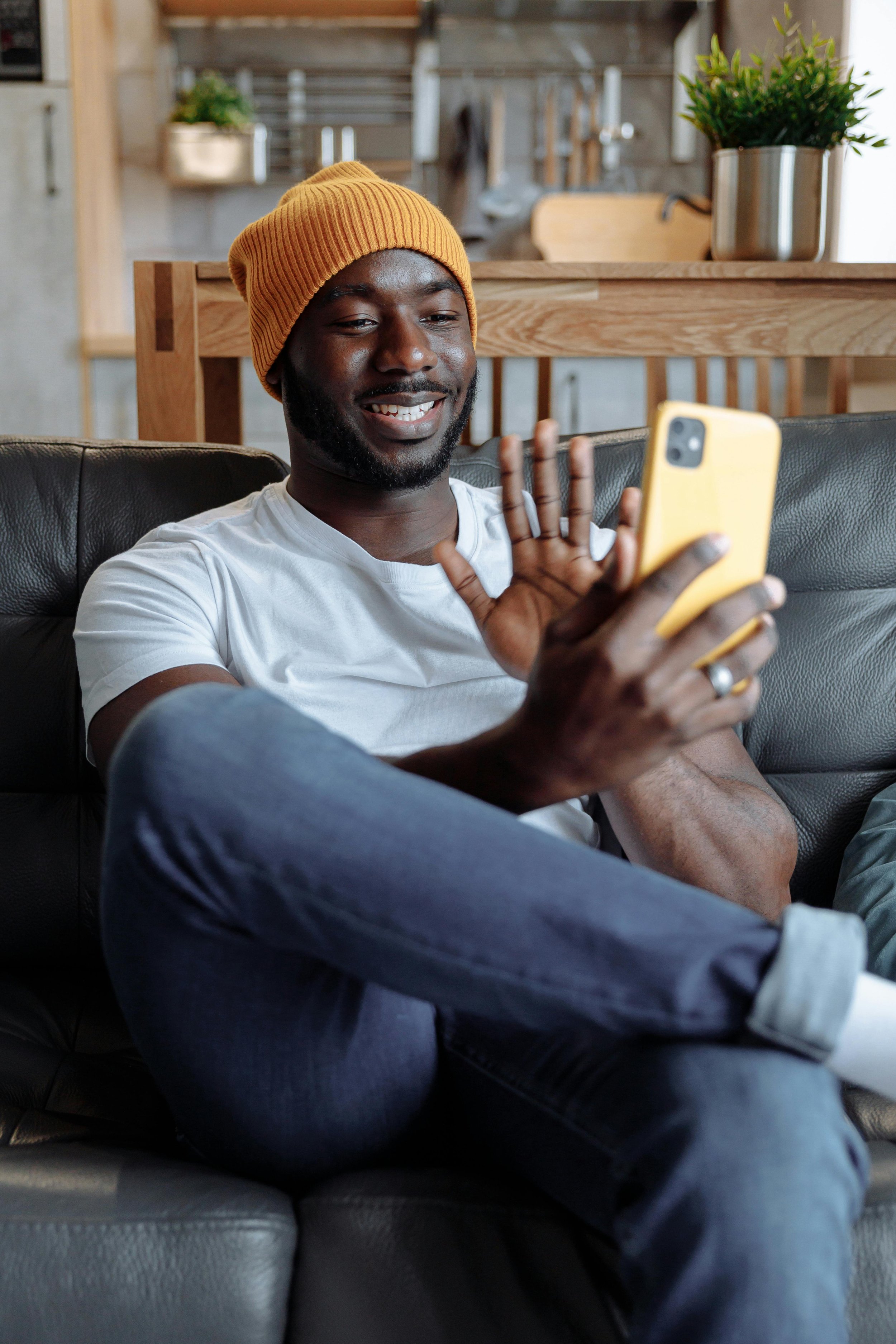 Therapist smiling and waving during a video call, representing supportive and relationship-centered marketing guidance