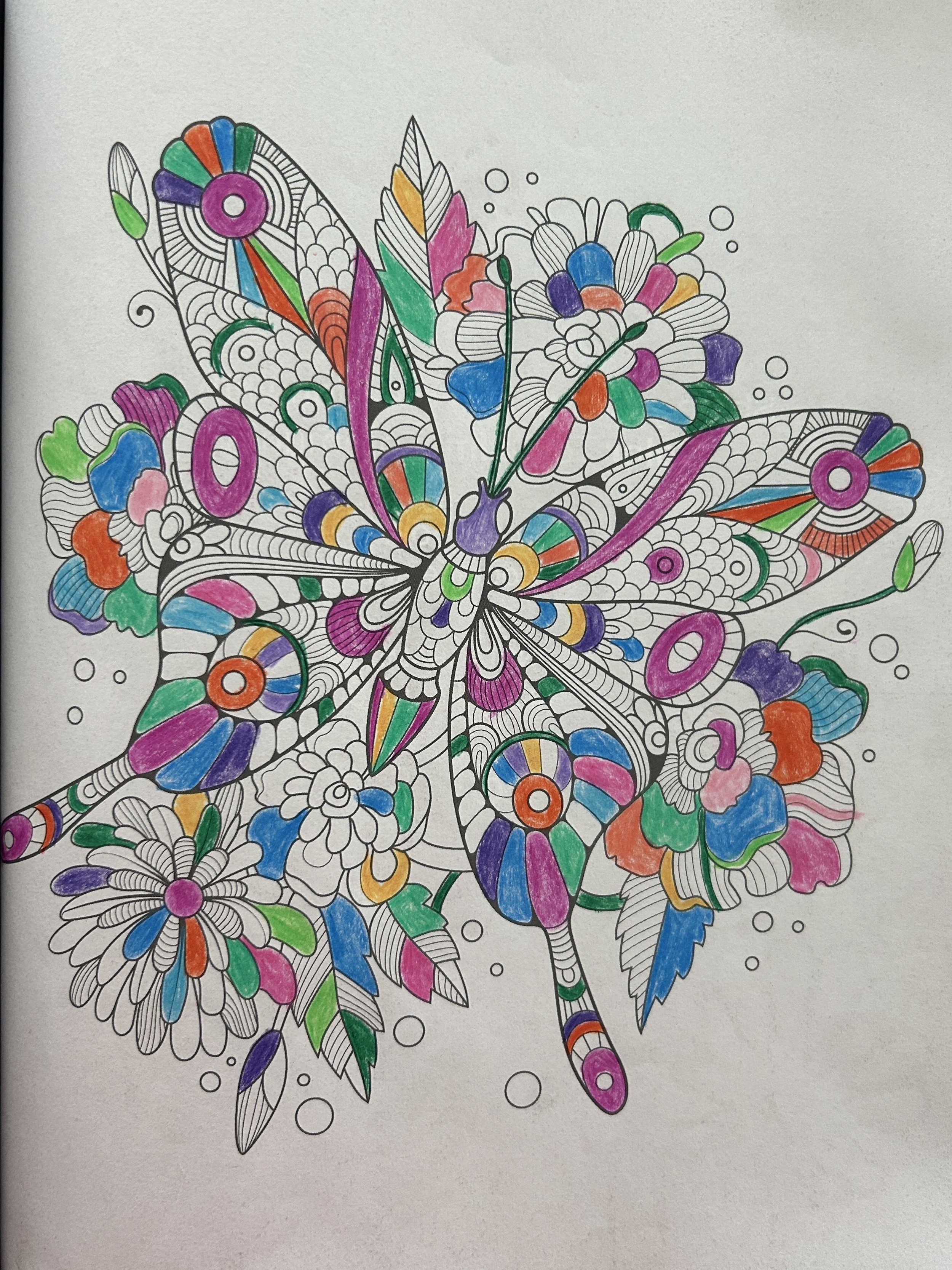 Coloring page of a butterfly with floral patterns, partially colored with markers including purple, orange, pink, green, blue, and yellow.