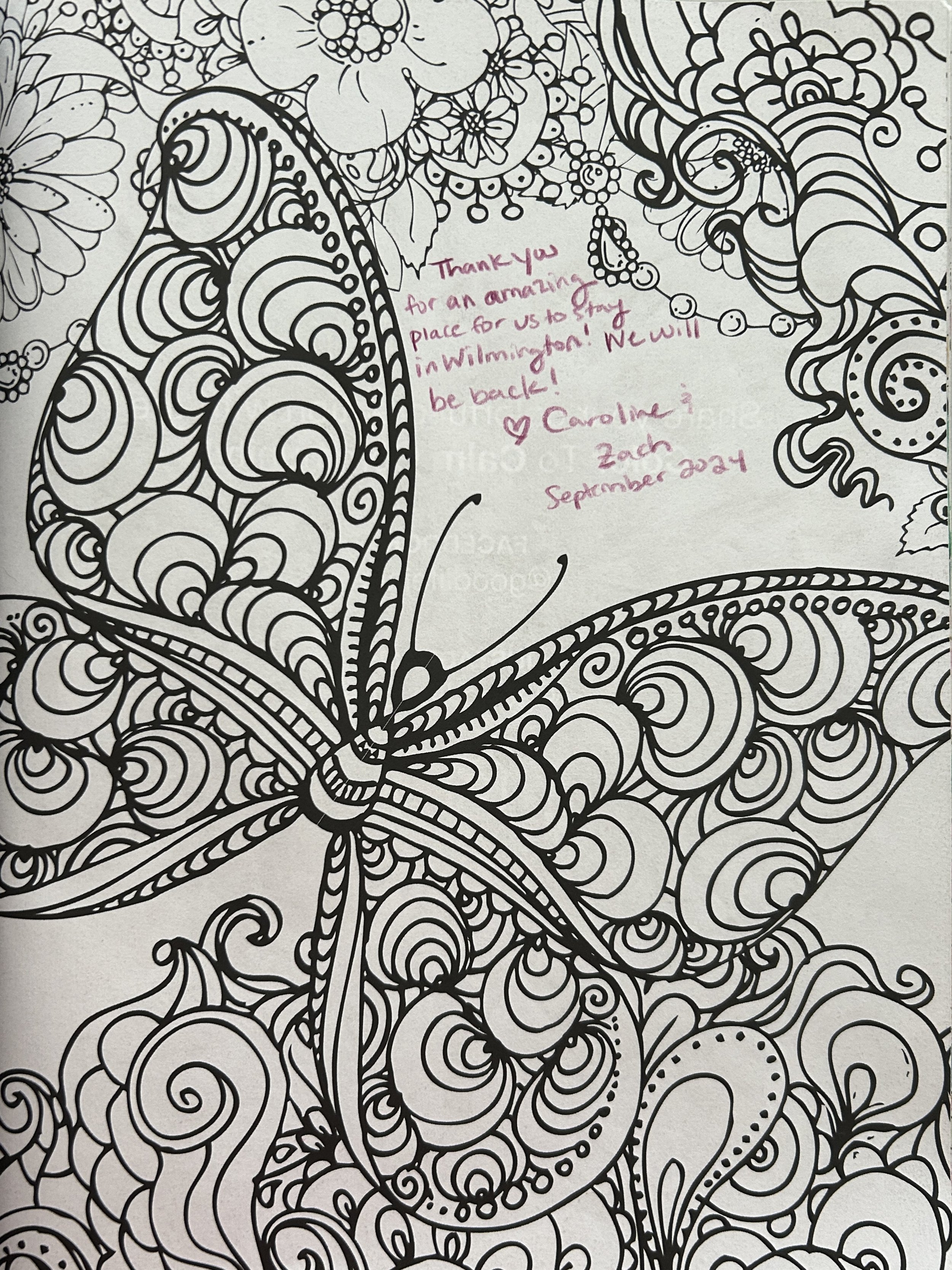 A detailed, black-and-white coloring page featuring a large butterfly with intricate, swirling patterns filling its wings, surrounded by additional ornate floral and abstract designs. There is a handwritten note in pink ink expressing gratitude from