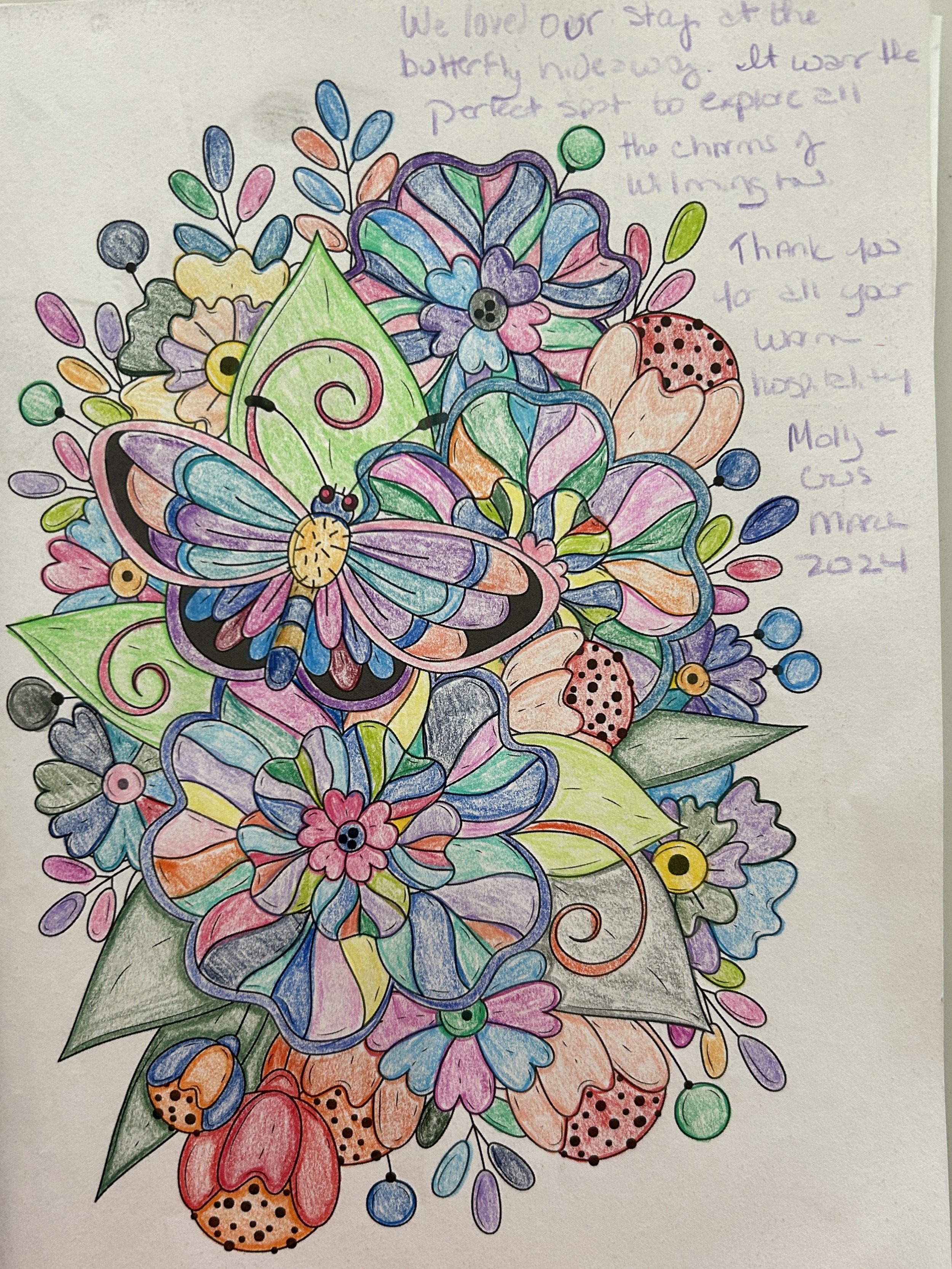 Colorful hand-drawn illustration of flowers, leaves, and a butterfly, with a handwritten note on the top right corner.