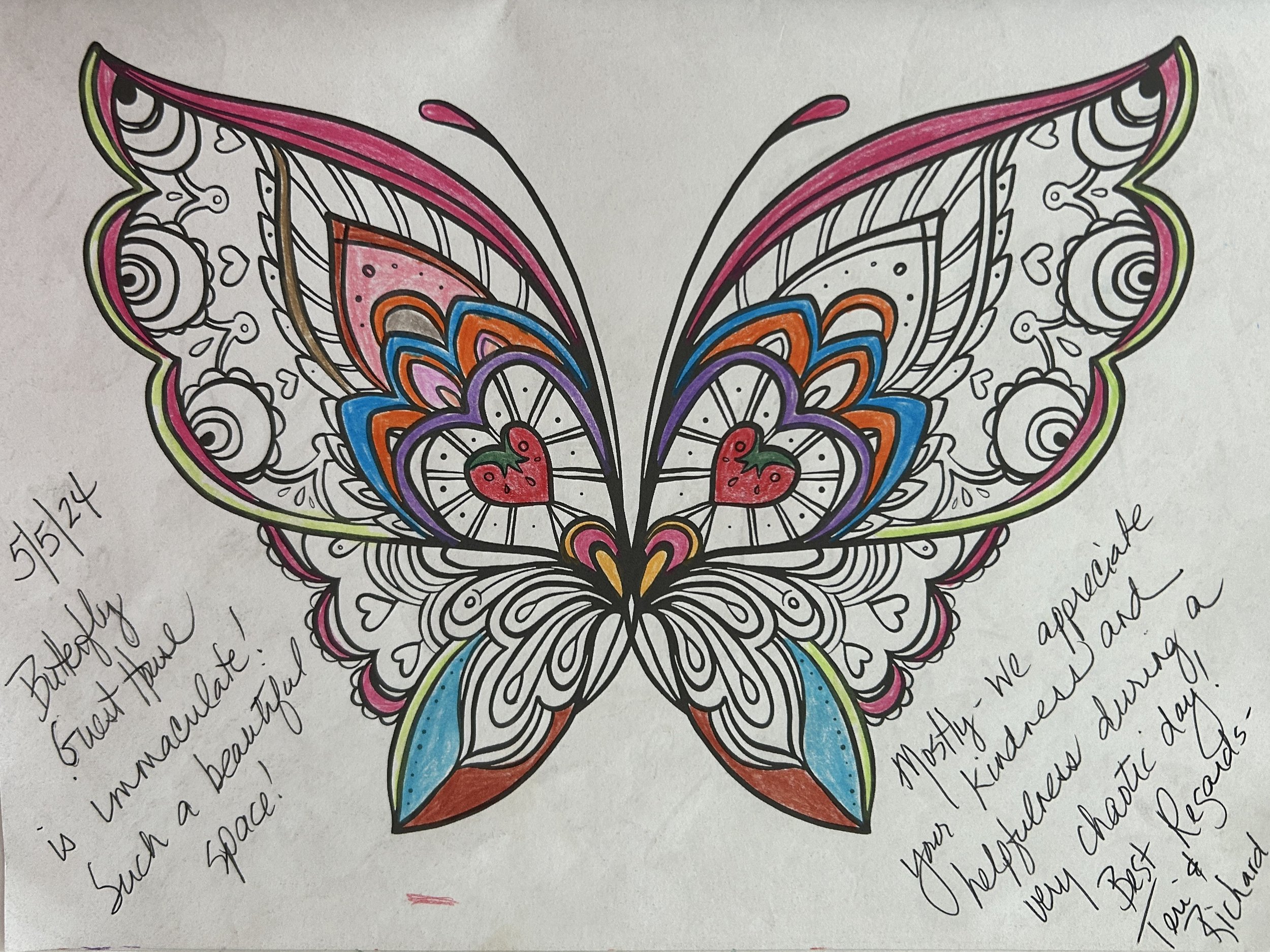 Colorfully decorated butterfly with hearts on its wings, surrounded by handwritten notes and messages.