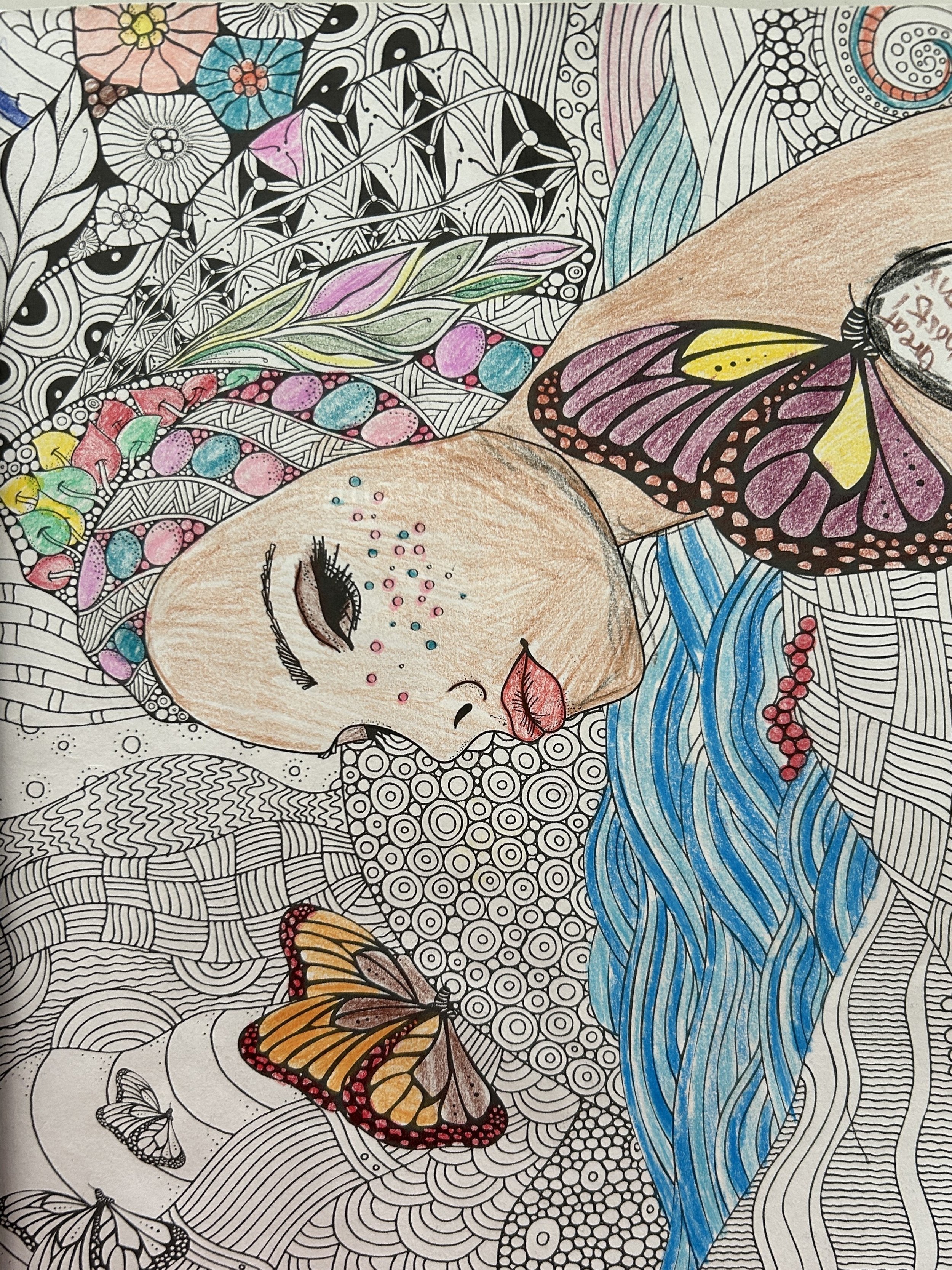 A colorful drawing of a woman sleeping with long blue flowing hair, surrounded by butterflies, flowers, and abstract patterns.