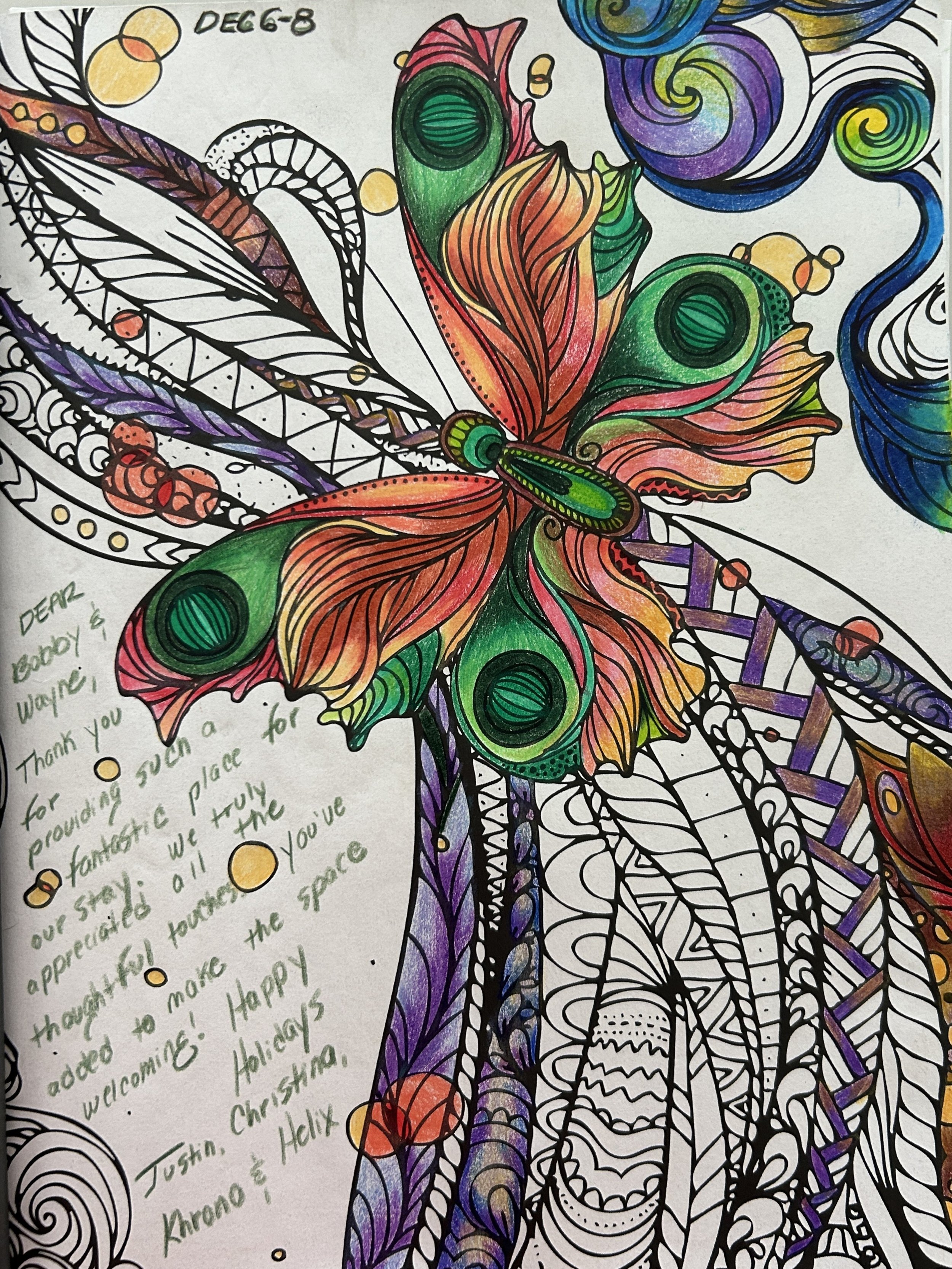 Colorful, intricate drawing of a butterfly with detailed wings, featuring various swirling patterns and vibrant colors, with a handwritten message on the left side.