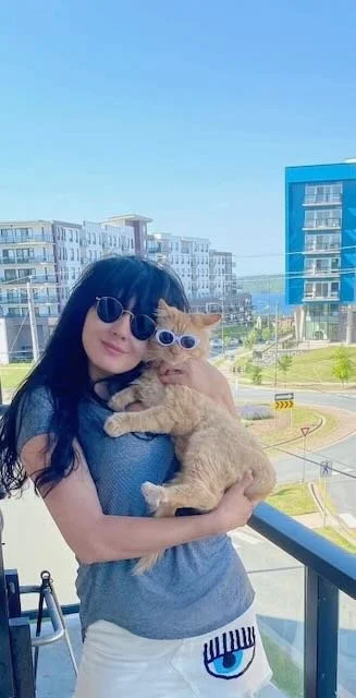 Nadia with her cat both in sunglasses