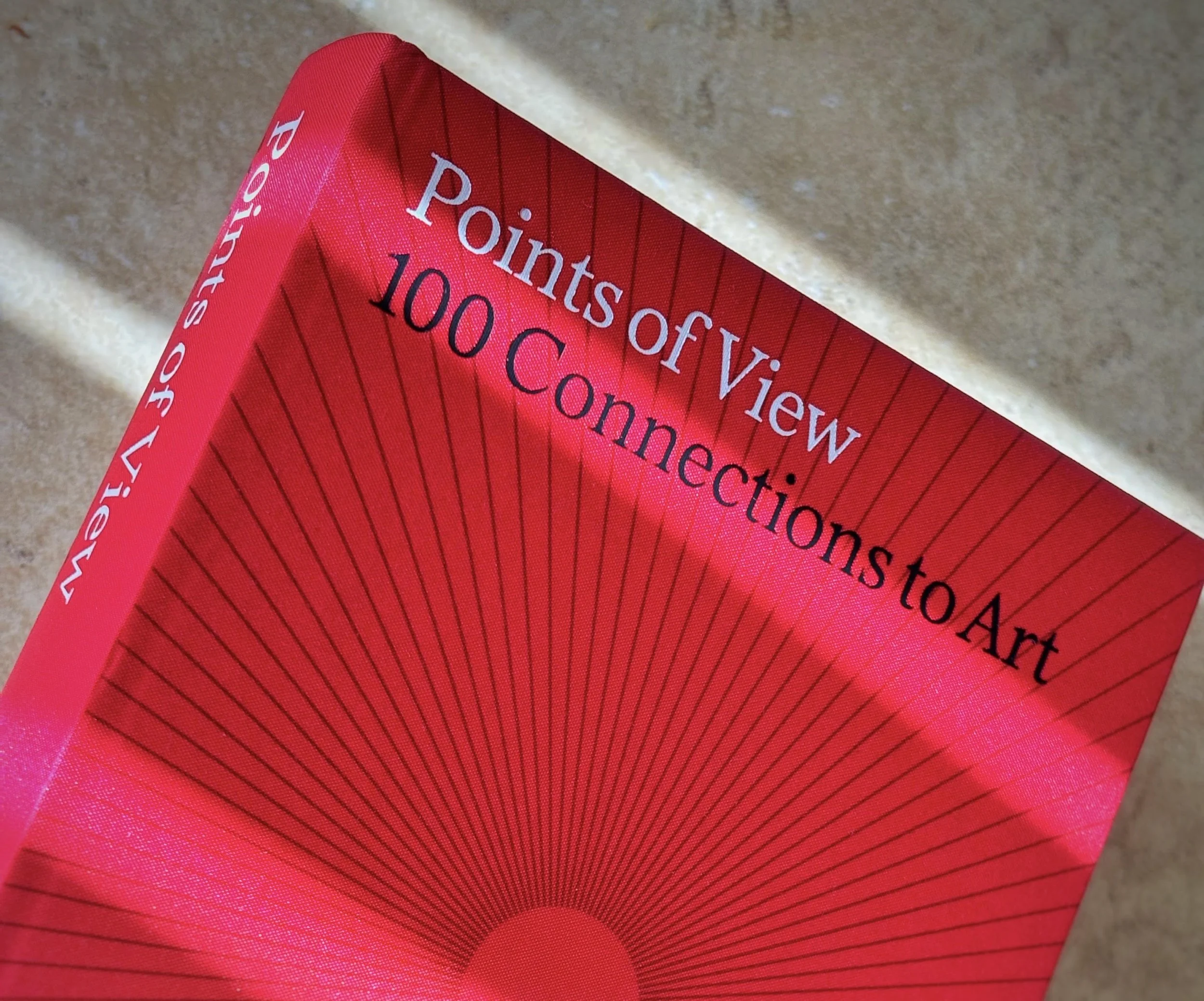 Detail of "Points of View" book cover highlighted by streaks of sunlight