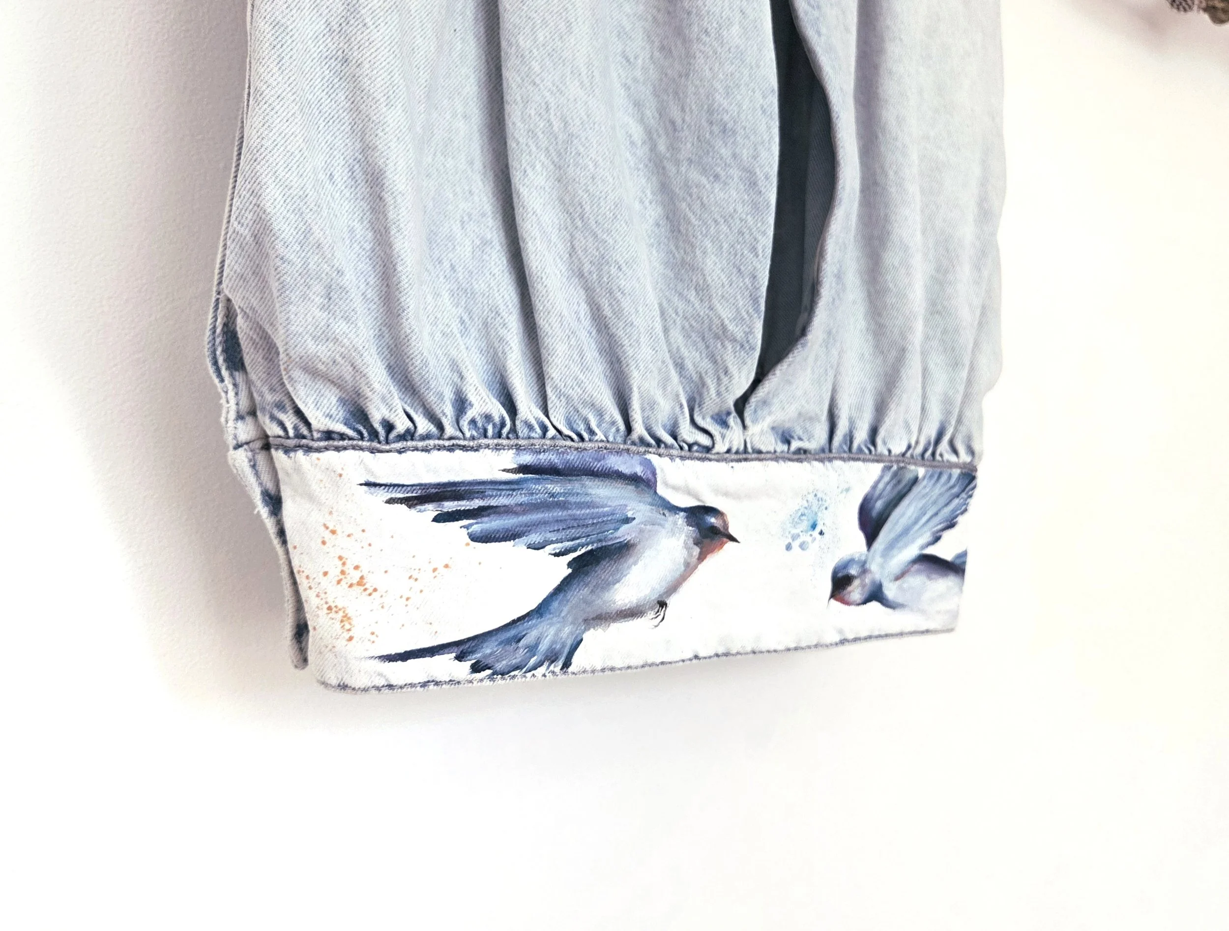 Painted birds on denim