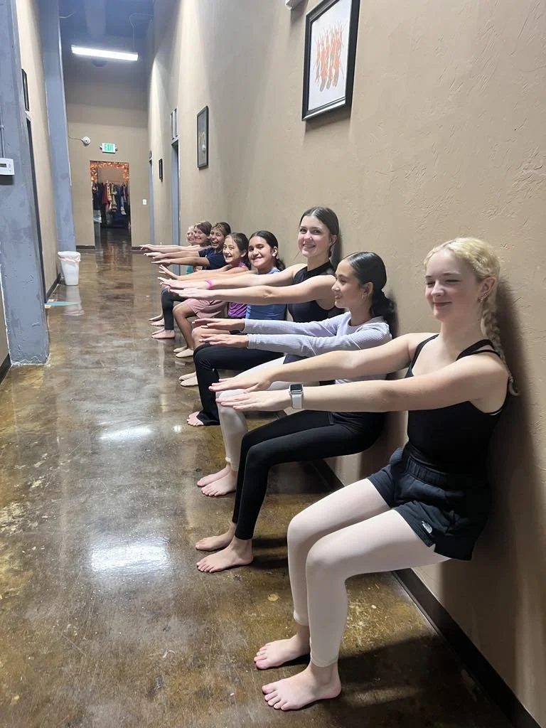 dancers doing wall-sits