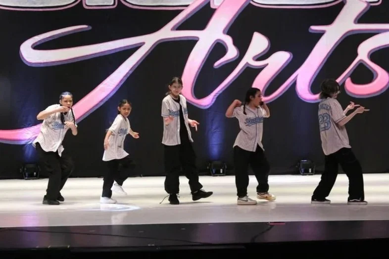 hip hop dancers in jerseys onstage
