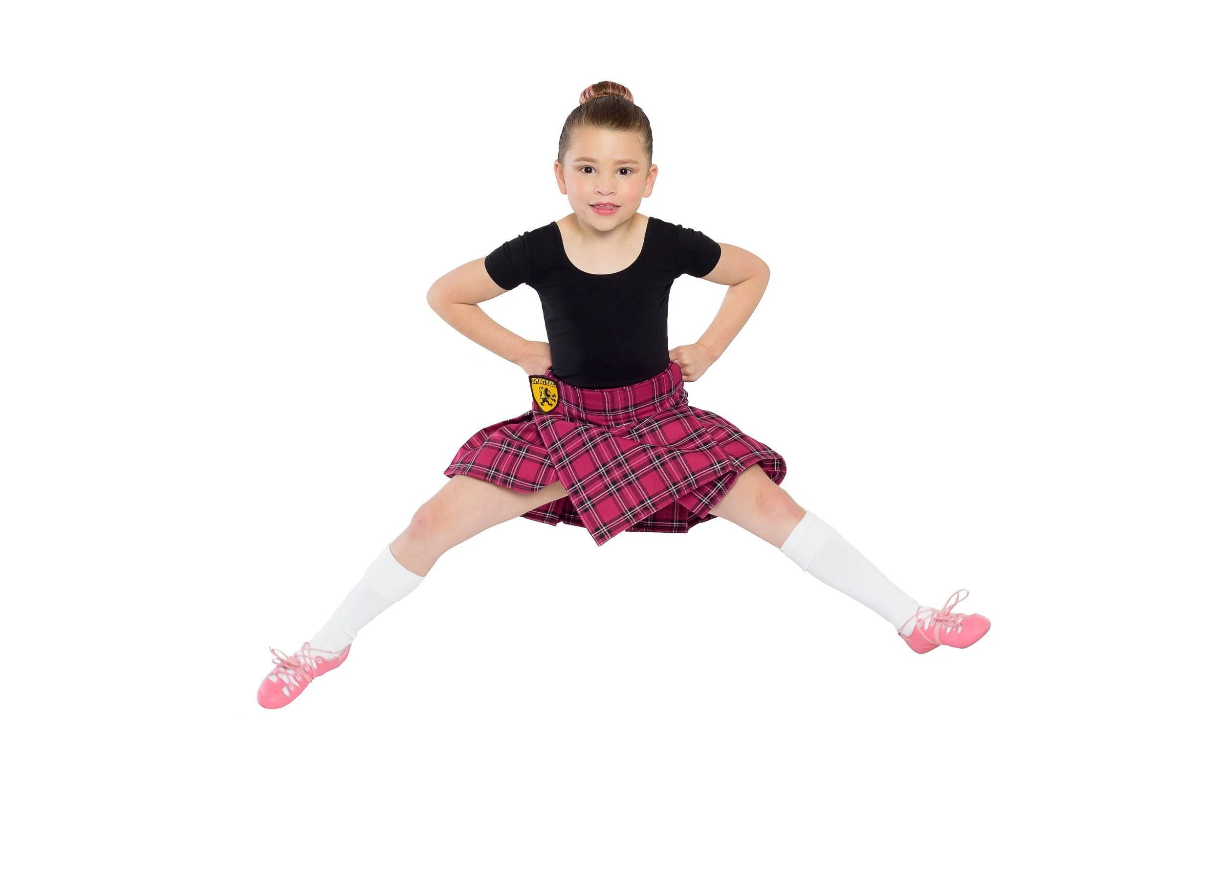 scottish highland dancer jumping in the air in a kilt