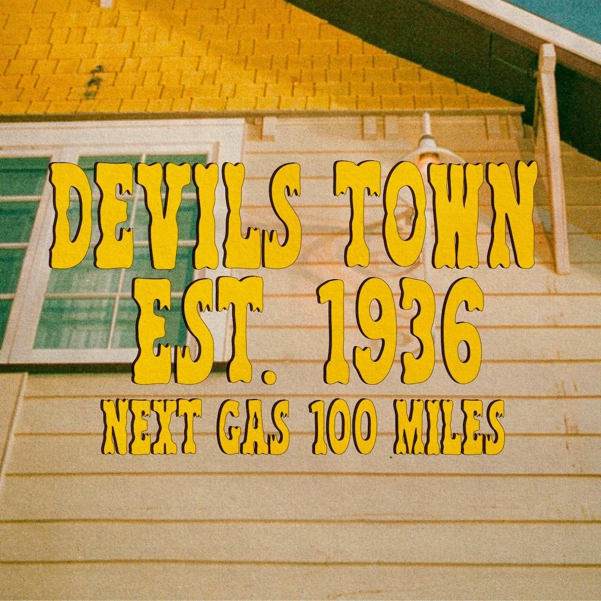 October Font - Devils Town. The letterforms are deliberately imperfect and full of small unsettling details. The T spreads like a pair of bat wings or a frayed curtain, while the S sits somewhere between dripping blood and a row of strange teeth. The
