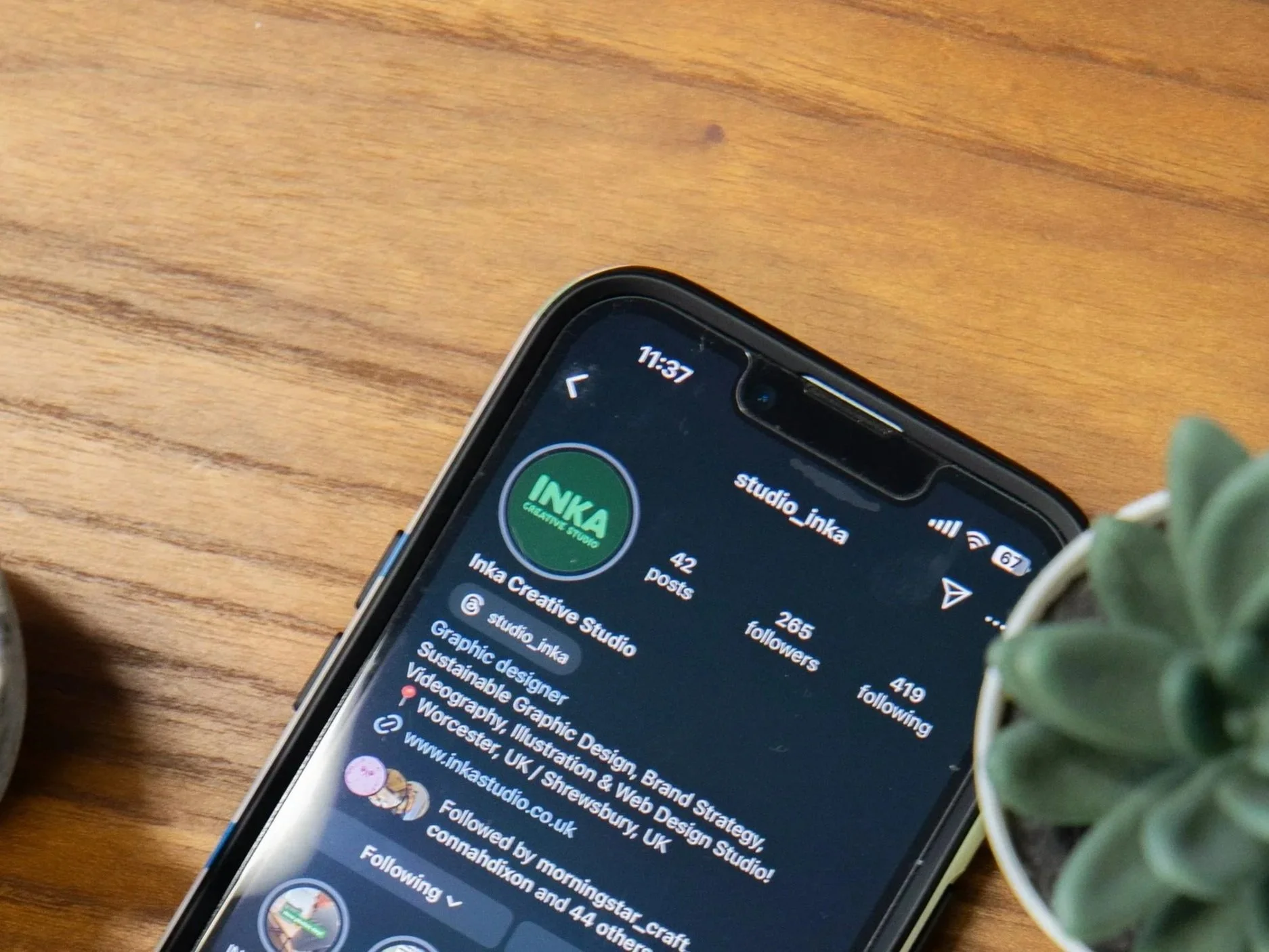 image of a phone with the Inka Creative Studio's instagram page.