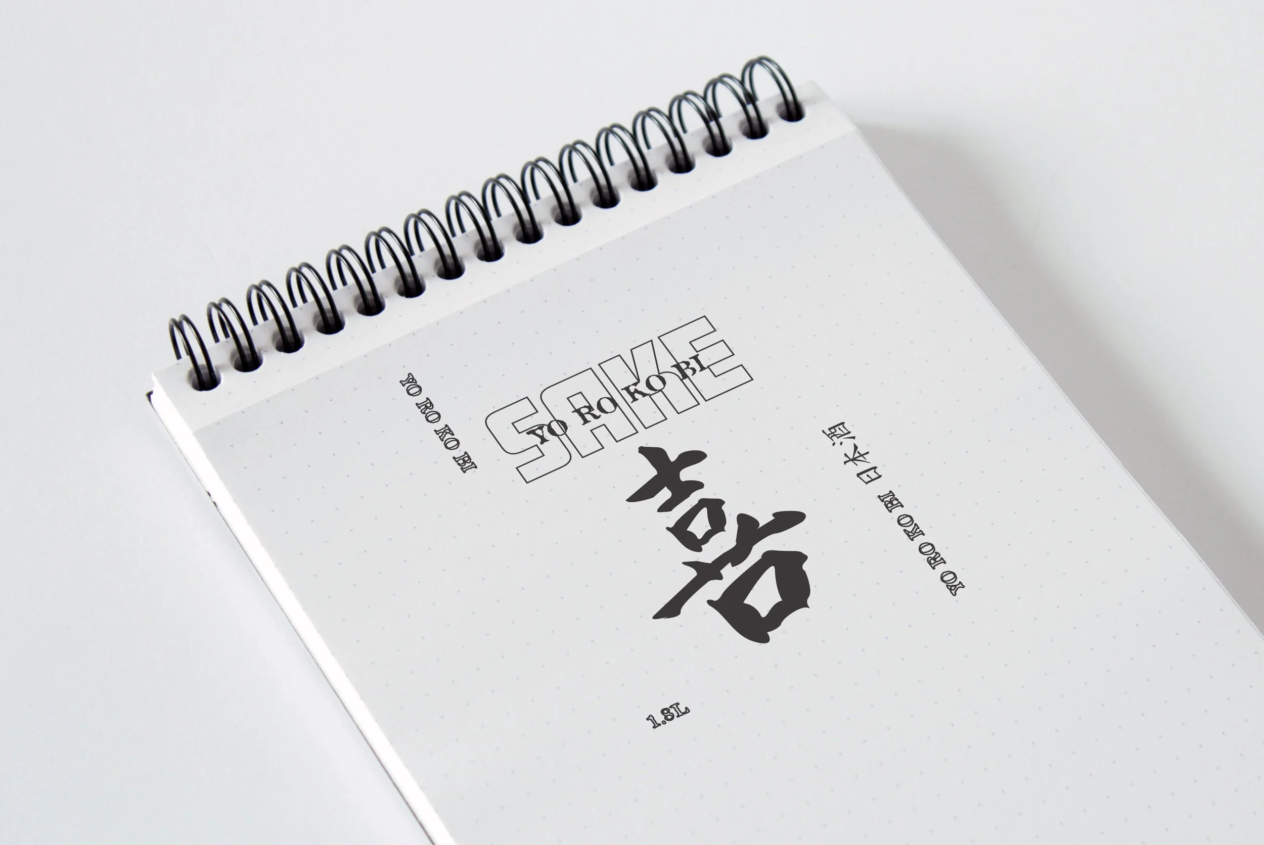 Image of the branding concept on a notepad in monochrome colour pallete