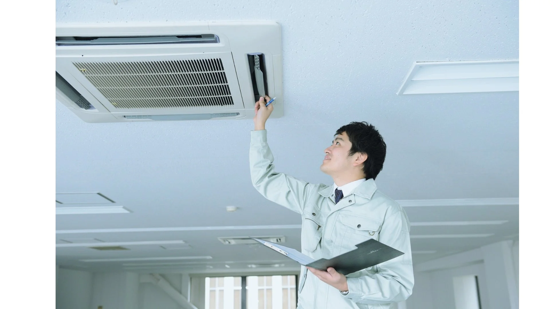 man inspecting an HVAC system