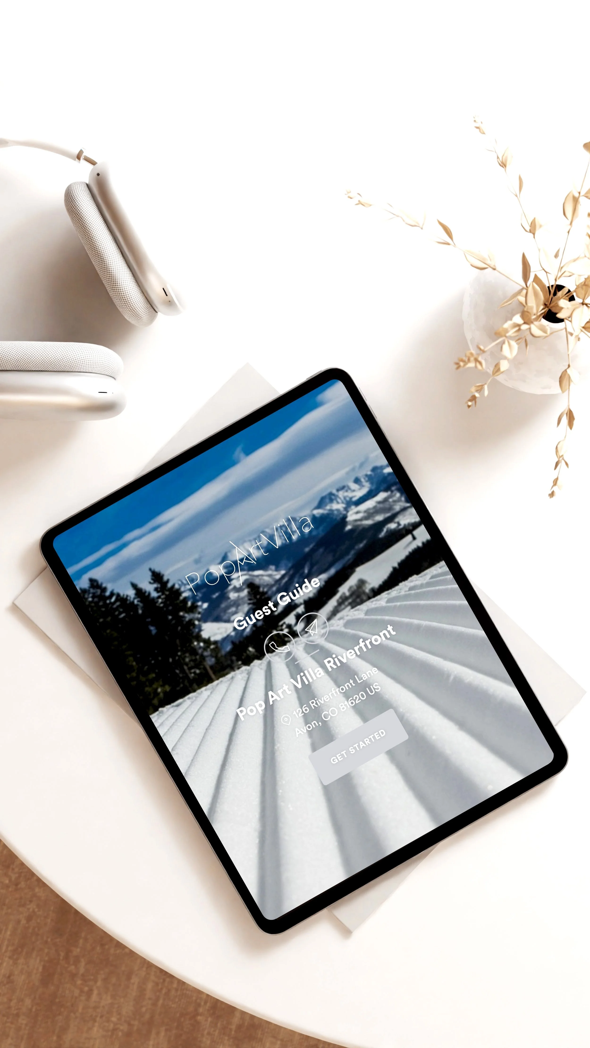 Pop Art Villa Guest Guide on iPad on neutral modern background